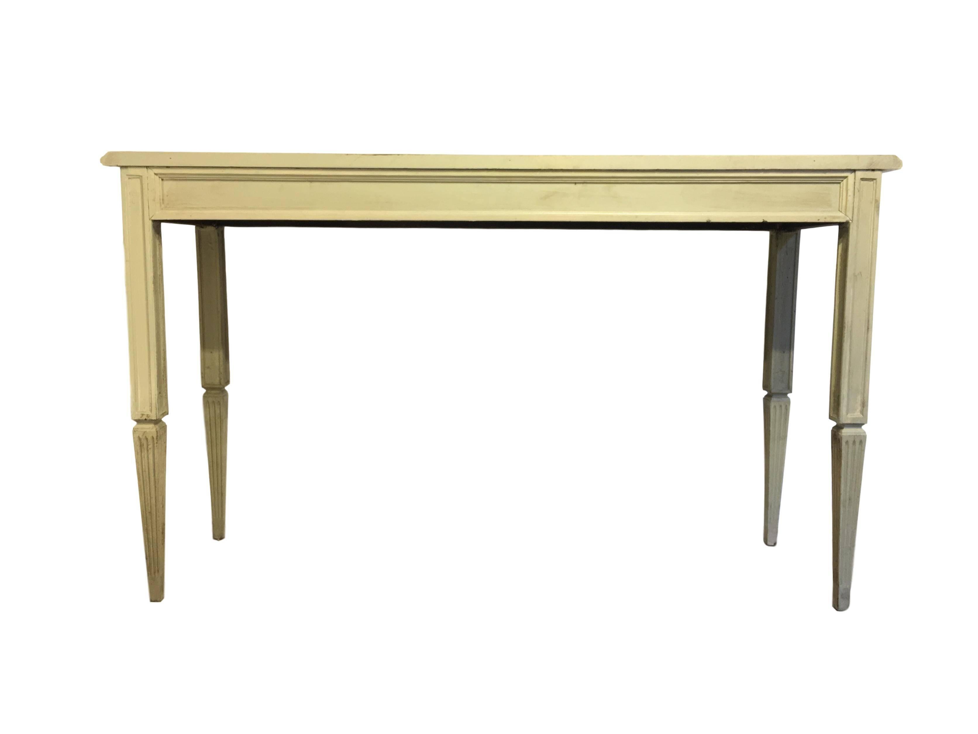 20th century painted cream beige console table with ornamental carved relief in the front.
 
