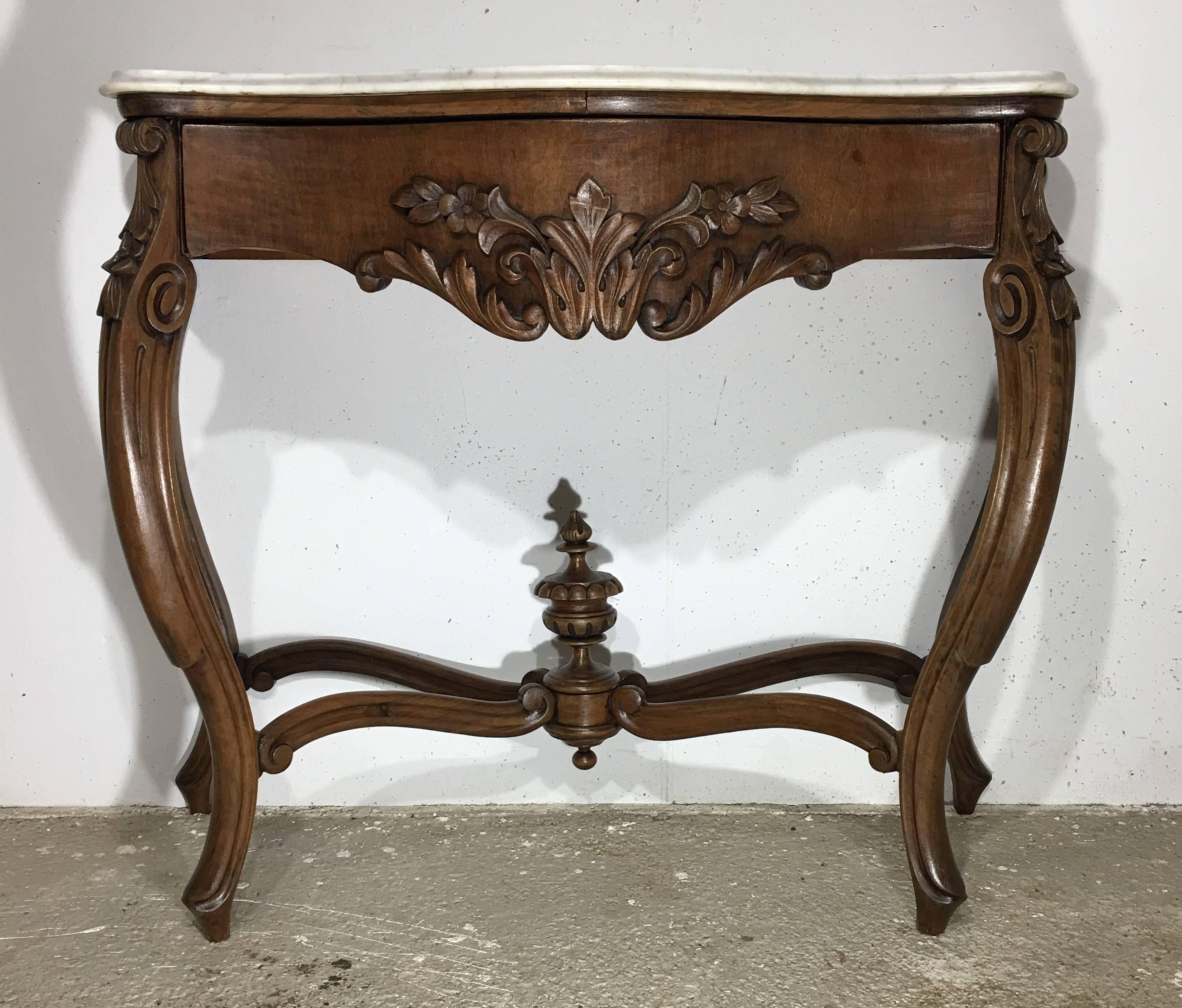 19th French Regency Carved Walnut Console Table with drawer & Marble top 

19th century French Regence style beautifully carved with leaves walnut console. White cream marble top with front drawer, over hand-carved frieze supported by four cabriole