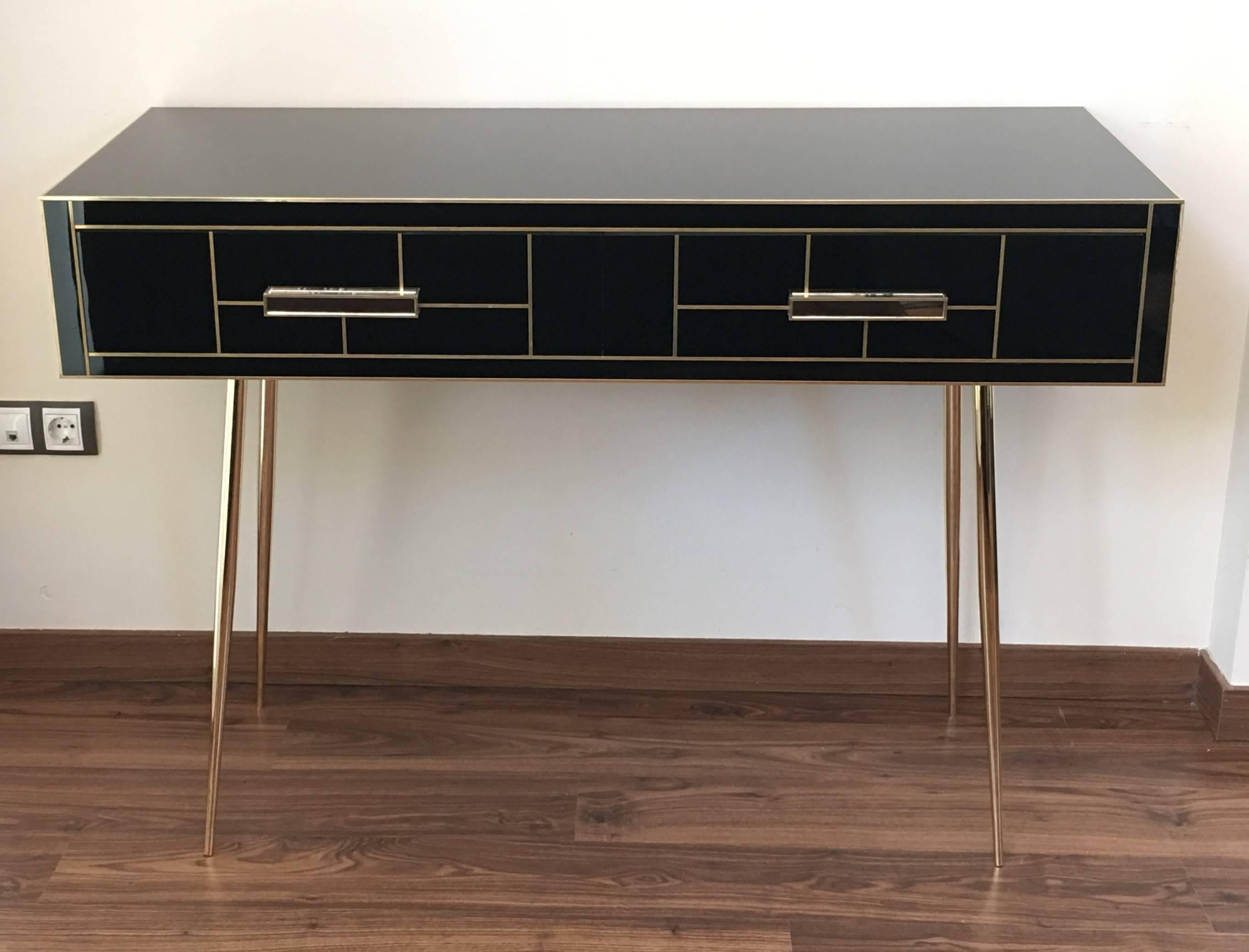 Handmade desk with two drawers with brake.
It´s also black mirrored behind.
The handles and the endless of the drawers are made in mirror.
The brass legs are very resistant’s.

Measures: Height of the leg: 25.5in.