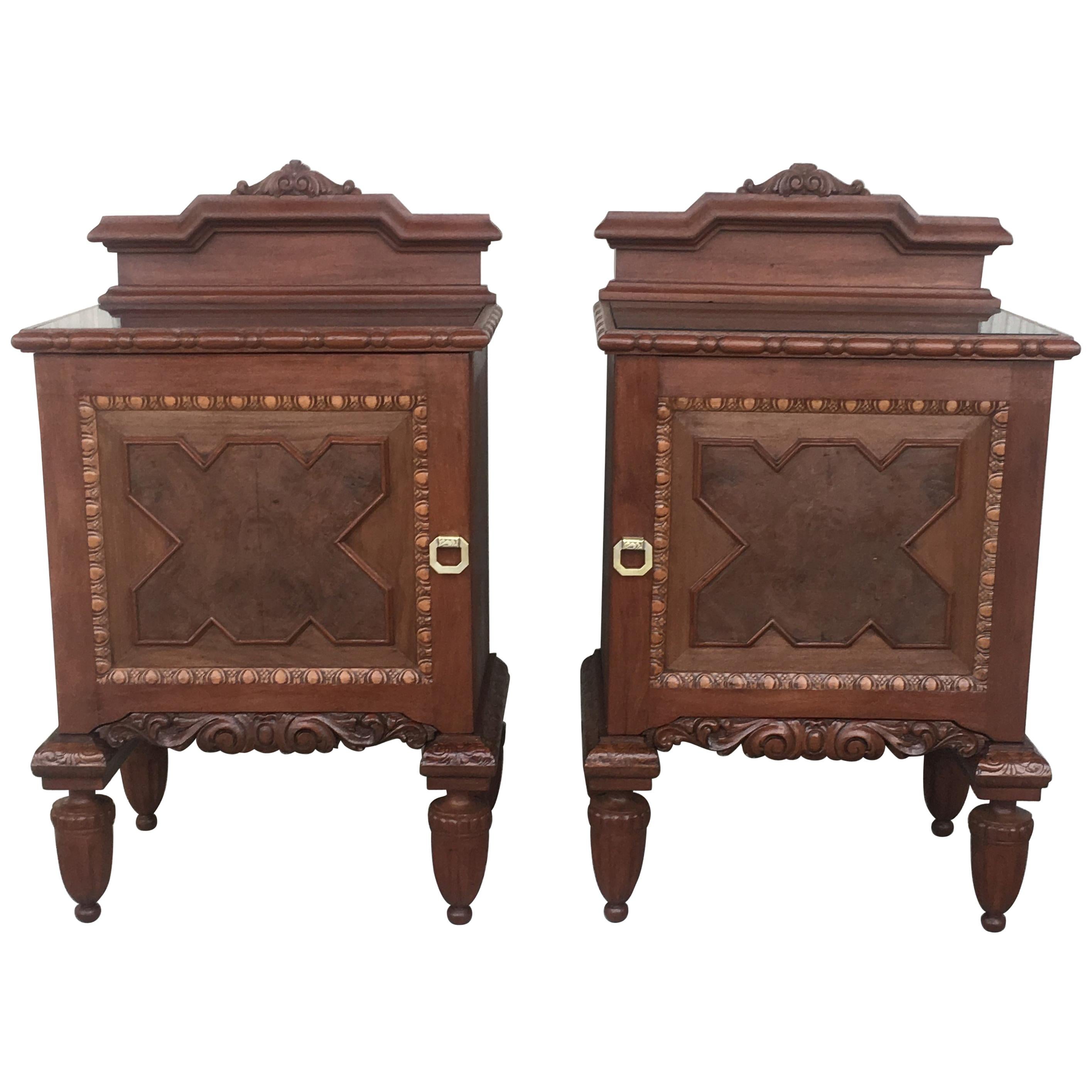 Pair of French Art Deco heavily hand carved bedside tables nightstands, 1920s.

French nightstands with some of the finest hand carved details with black glass in the tops.
