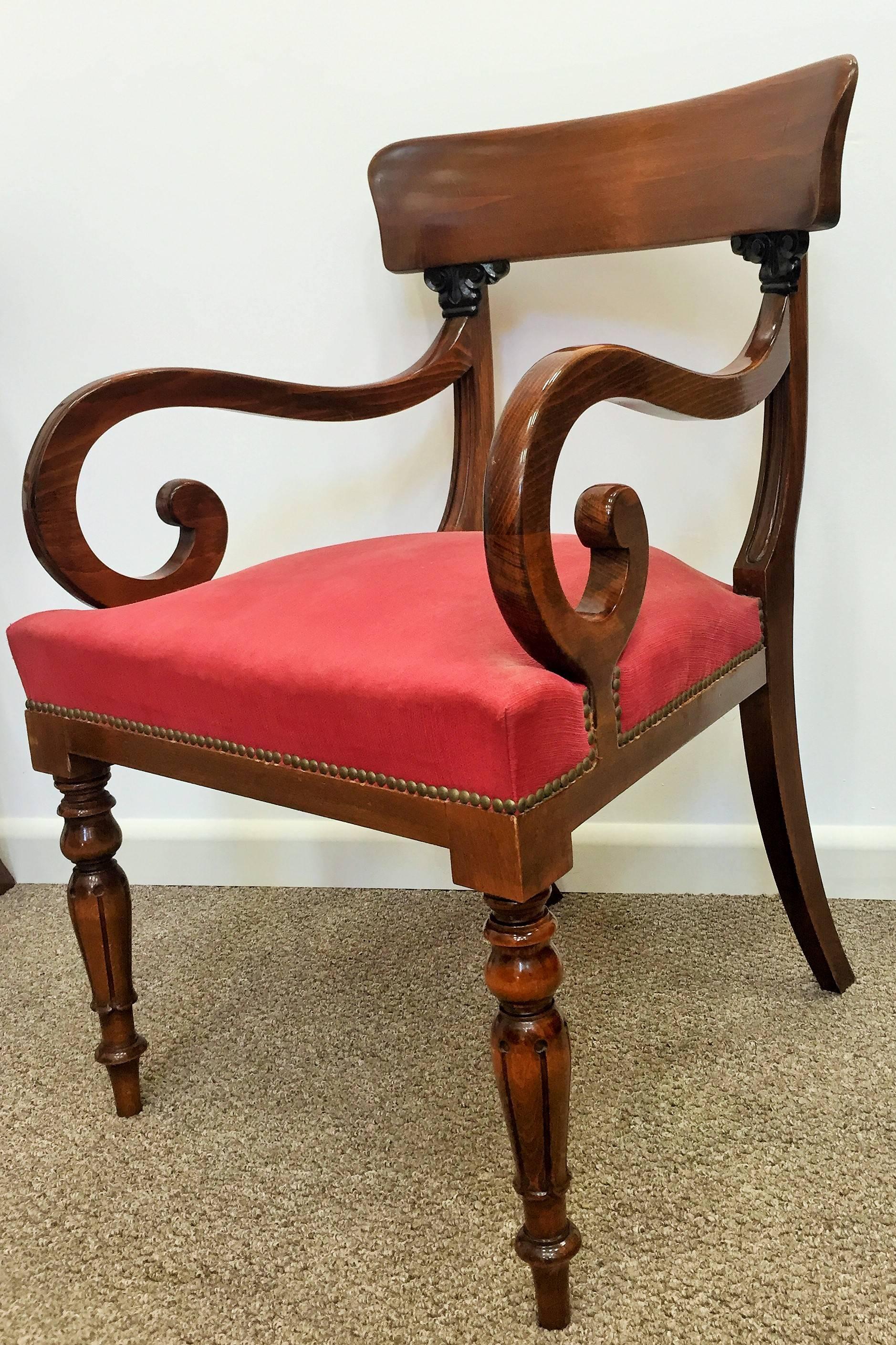 In mahogany and on carved feet with brass castors, the scroll arms with carved anthemion leaves at the top. In very good condition.