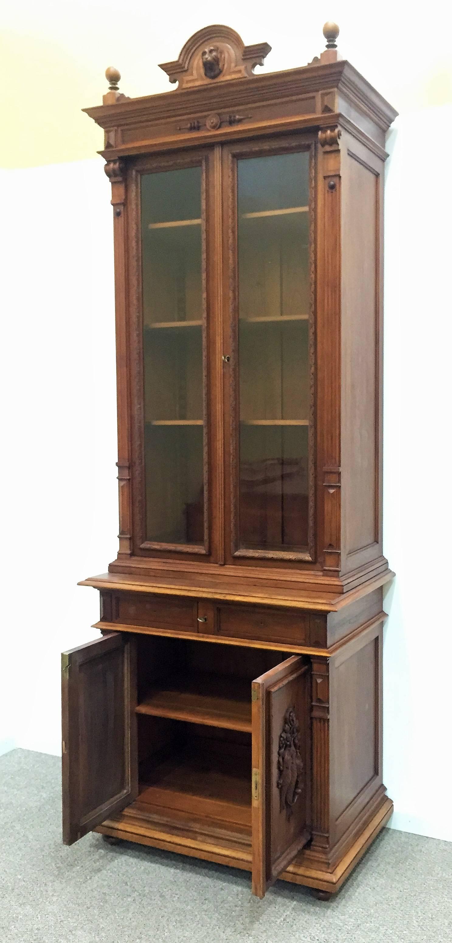 Phenomenal original antique French Louis Philippe cabinet, bibliotheque or showcase. This fine antique offers an unusual height of almost 10 feet generously offering a plethora of storage and display opportunities. Two antique wavy glass doors up