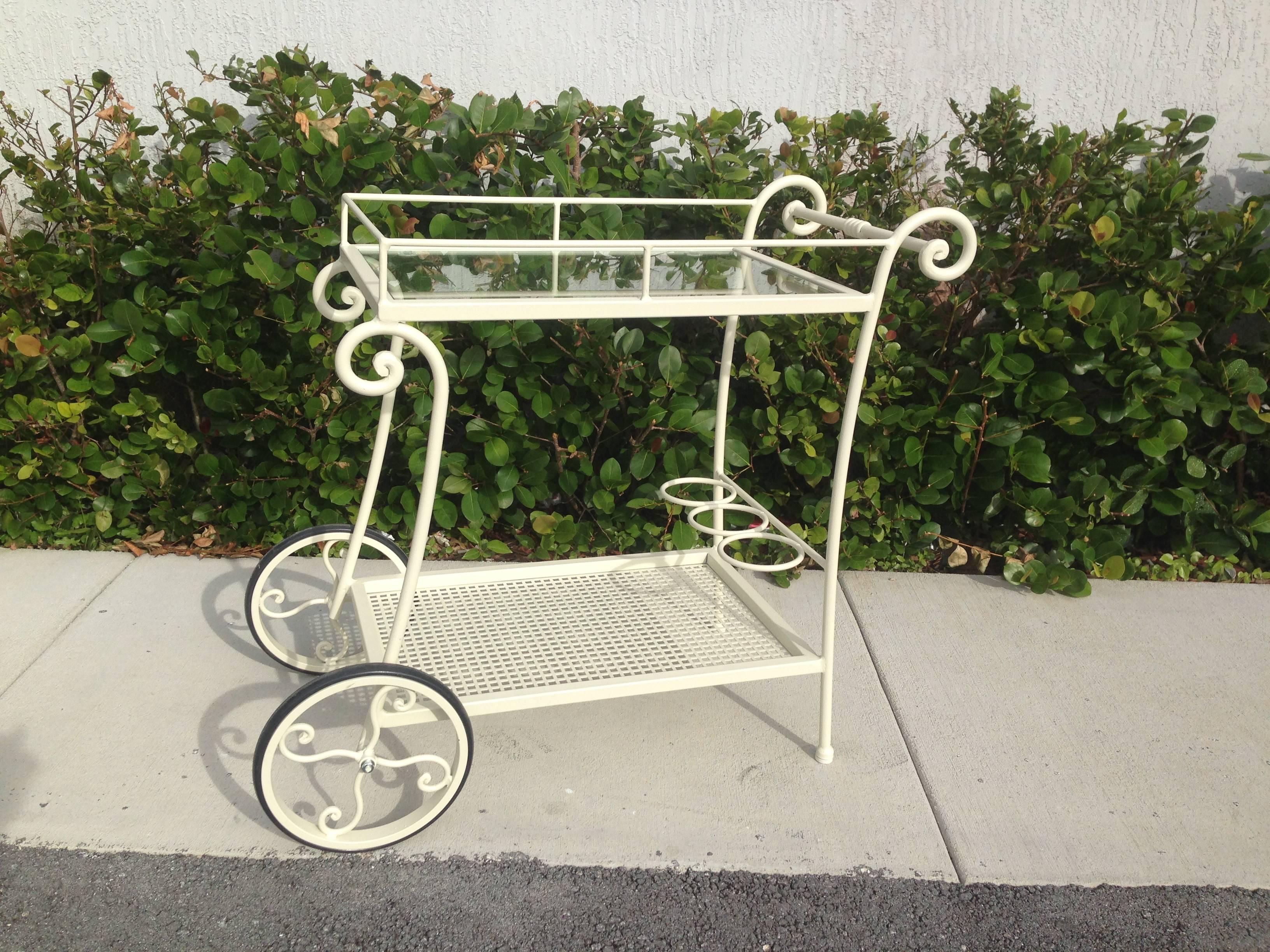 Wrought iron tea cart.
Perfect for a collected garden of potted plants, or extra kitchen storage, this wrought iron tea cart is finished in a fresh white color.