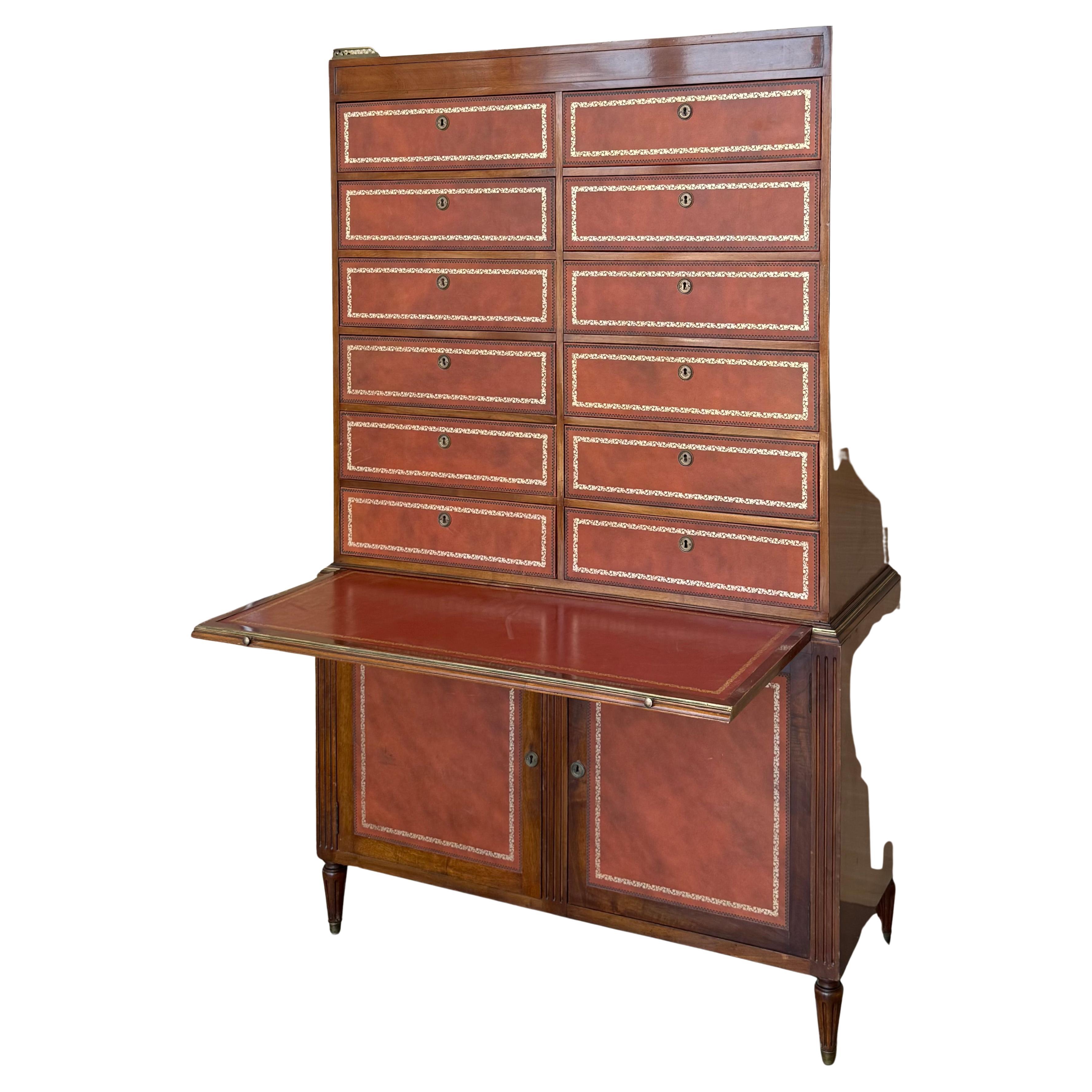 Very rare leather wrapped vintage bachelor chest in the Chippendale Style. This fine piece features 12 dovetailed drawers, solid wood construction, bracket feet, all wrapped in original distressed orange tooled leather drawer fronts, it has a hidden