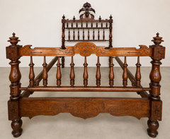 Ornately Carved Antique Wooden Bed Frame with Turned Spindles and Crest