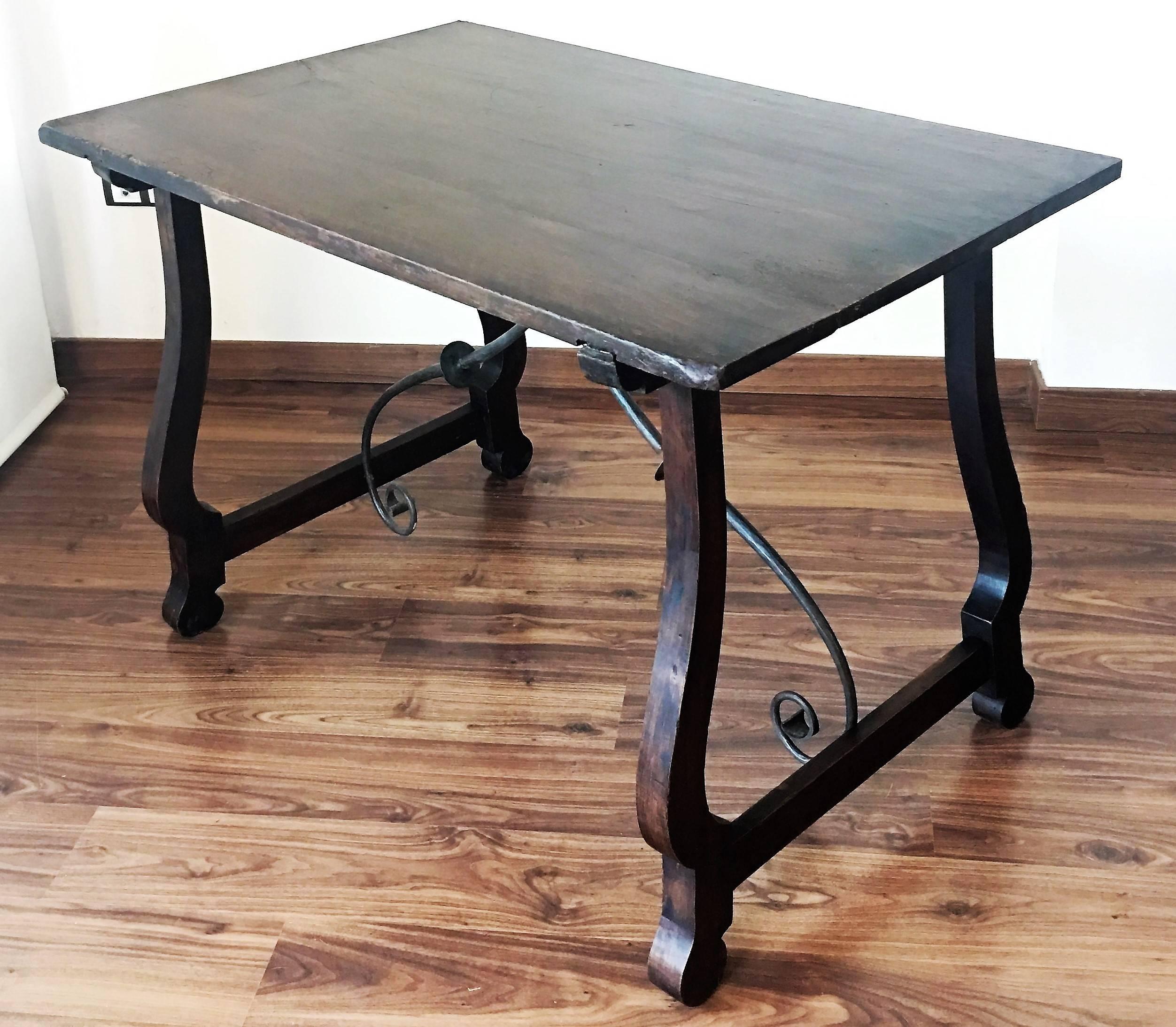 This chestnut refectory table with lyre or harp form supports and original iron stretchers. Its robust but elegant style will definitely stand out in your home or office. 

A refectory table is a long narrow table supported by heavy legs or trestles