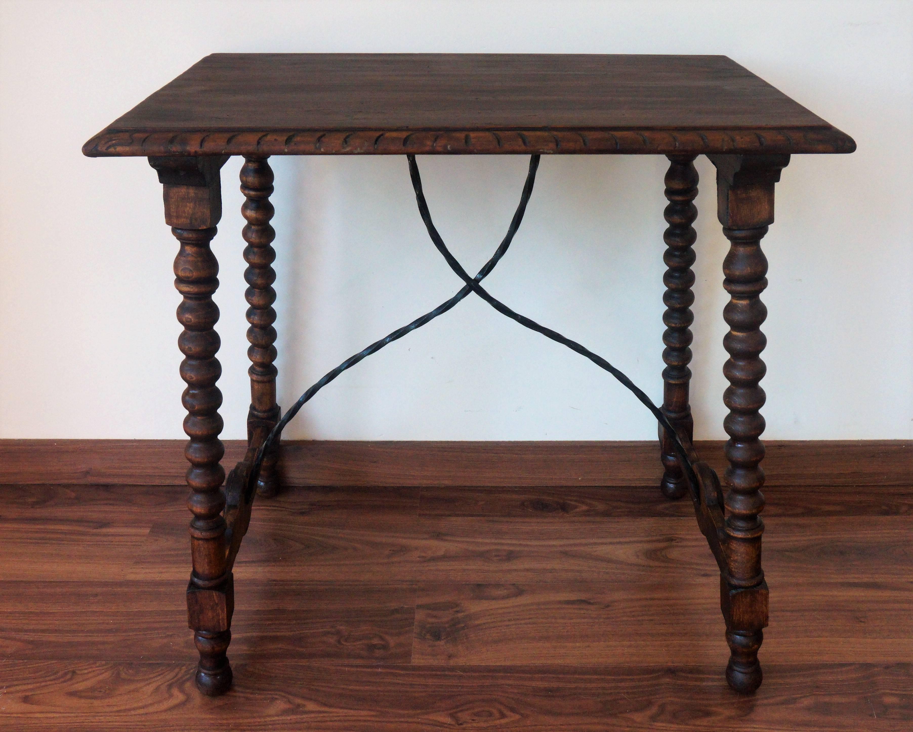 19th century Spanish side table.
19th century Spanish trestle table in walnut and iron. This piece has a great scale, lovely turned legs and iron stretcher. The top is made from a single piece of wood. This table could be used as an end table,