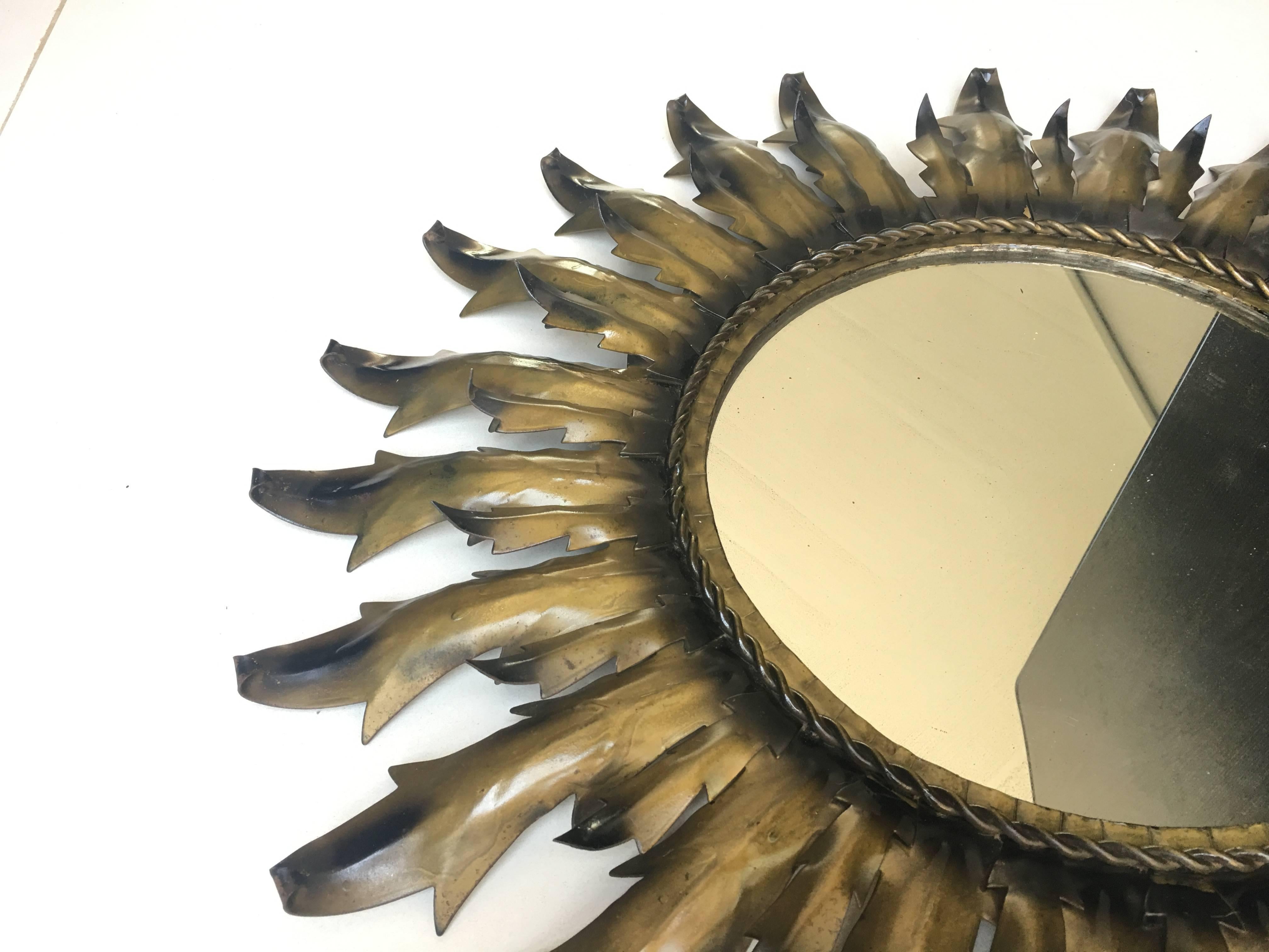 This stunning sunburst mirror in gilded iron is a lovely size and features convex bulls-eye glass, a nicely-patinated gilded surface.


Mirror diameter 11in

