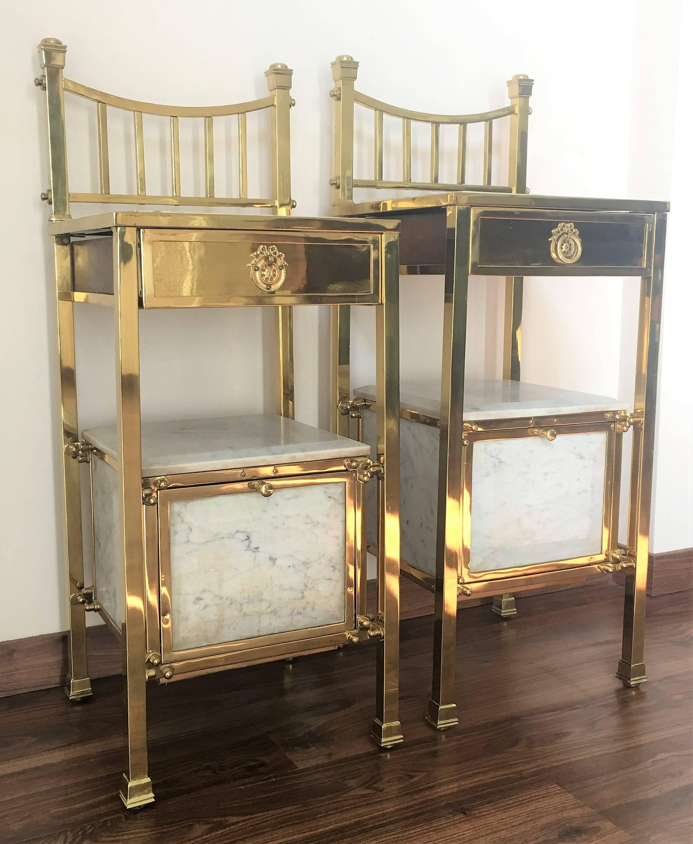 20th century pair of French two-tier nightstands or side tables, marble tops, brass and wooden shelves adorned with ornamental and original brass handle .