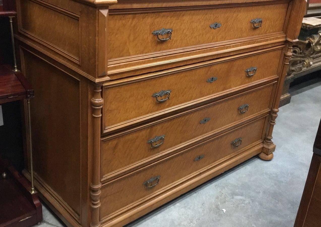 Of a rare bigger size, this bookmatched burl walnut Louis Philippe period commode with its original marble top. With four drawers, this handsome piece possesses both simplicity of line as well as the characteristic beauty of the wood found in Louis