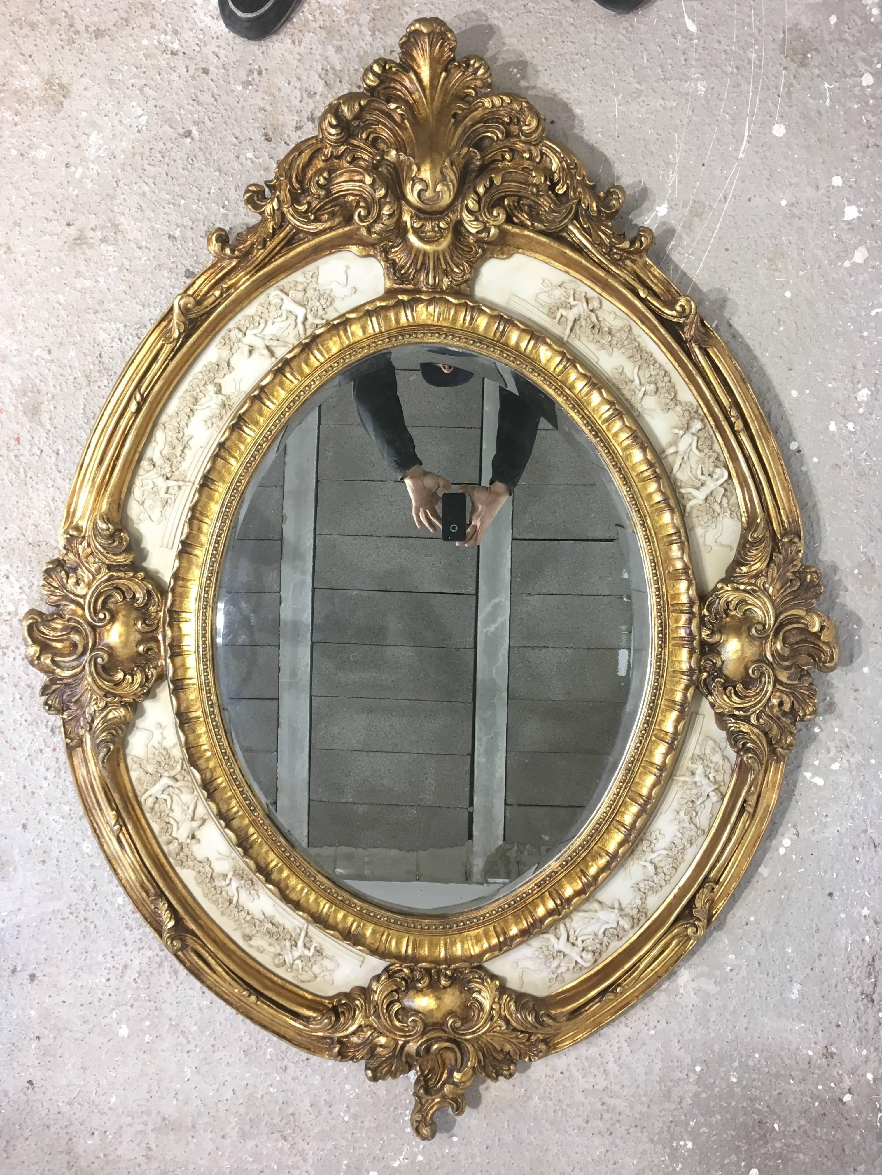 19th French Empire period gilt wood oval mirror with carved "marmolina"