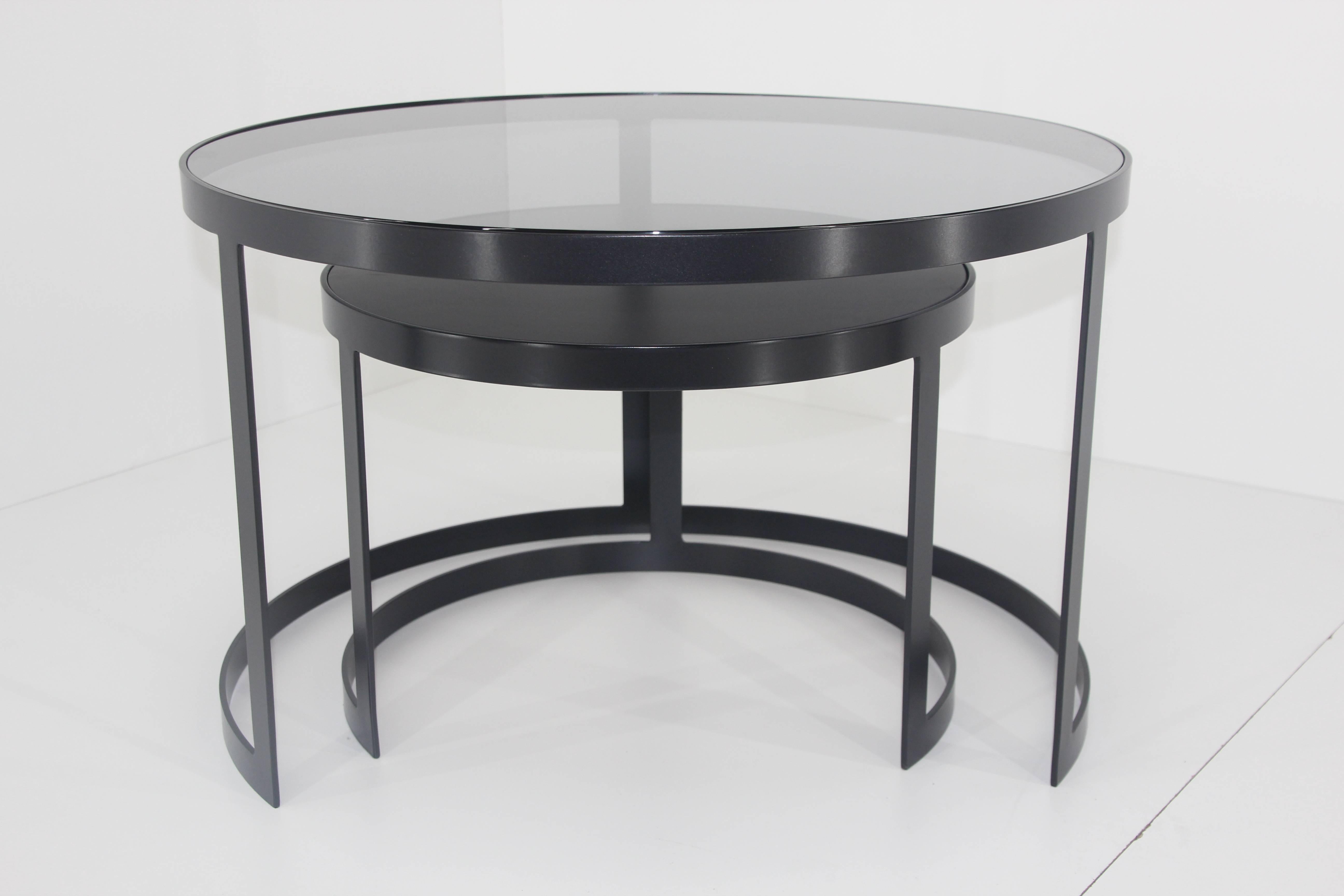 21st century set of two iron nesting tables with glass and wood tops, Spain

Frame material: Extruded and hand-welded Iron rods
Frame finish: Black 
Iron rods dimensions: 1.96 in x 0.1 in
Top: 0.4in. wood / 0.4in. glass

Table