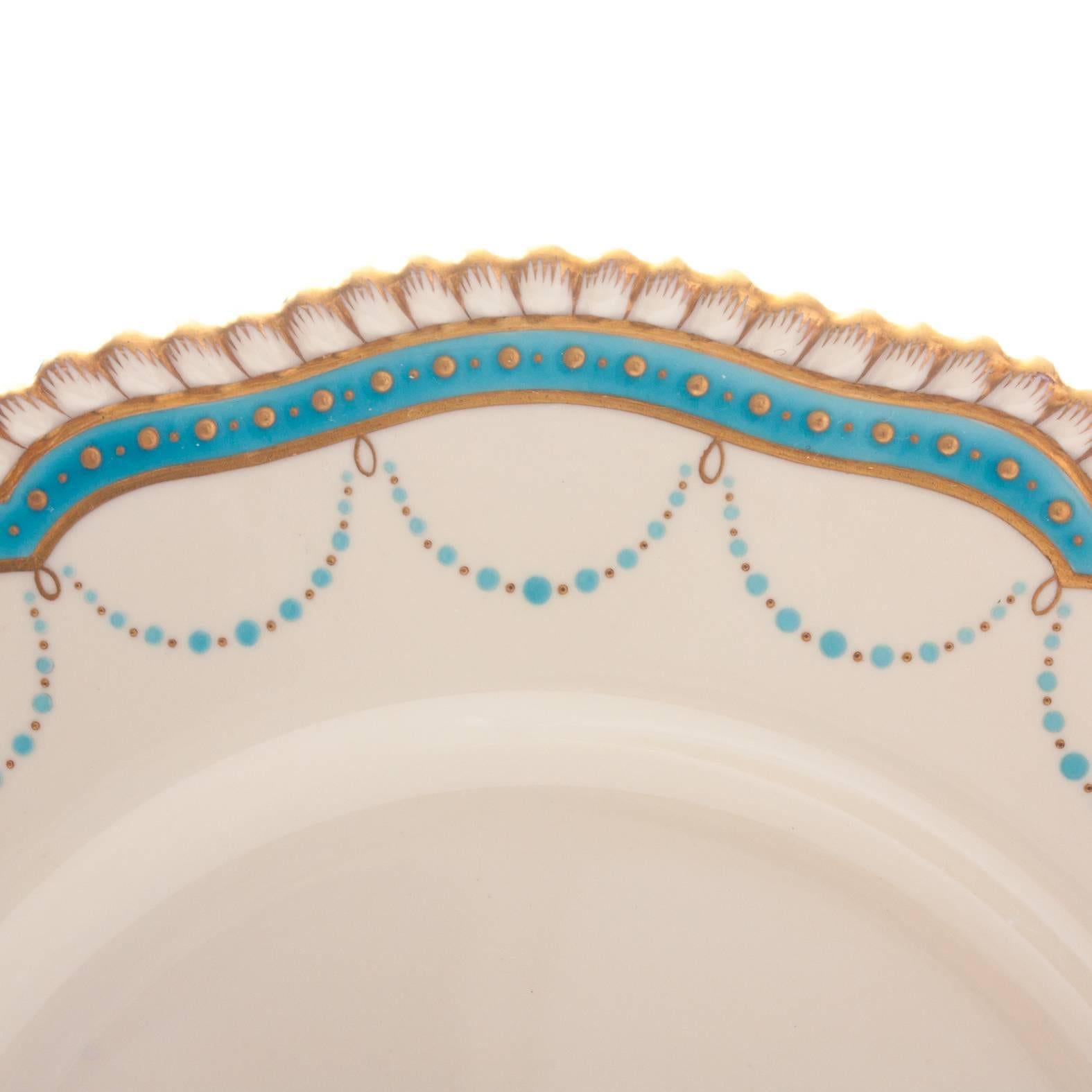 A set of Spode, England Dinner Plates featuring a lovely gadroon edge and highlighted with hand crafted turquoise 