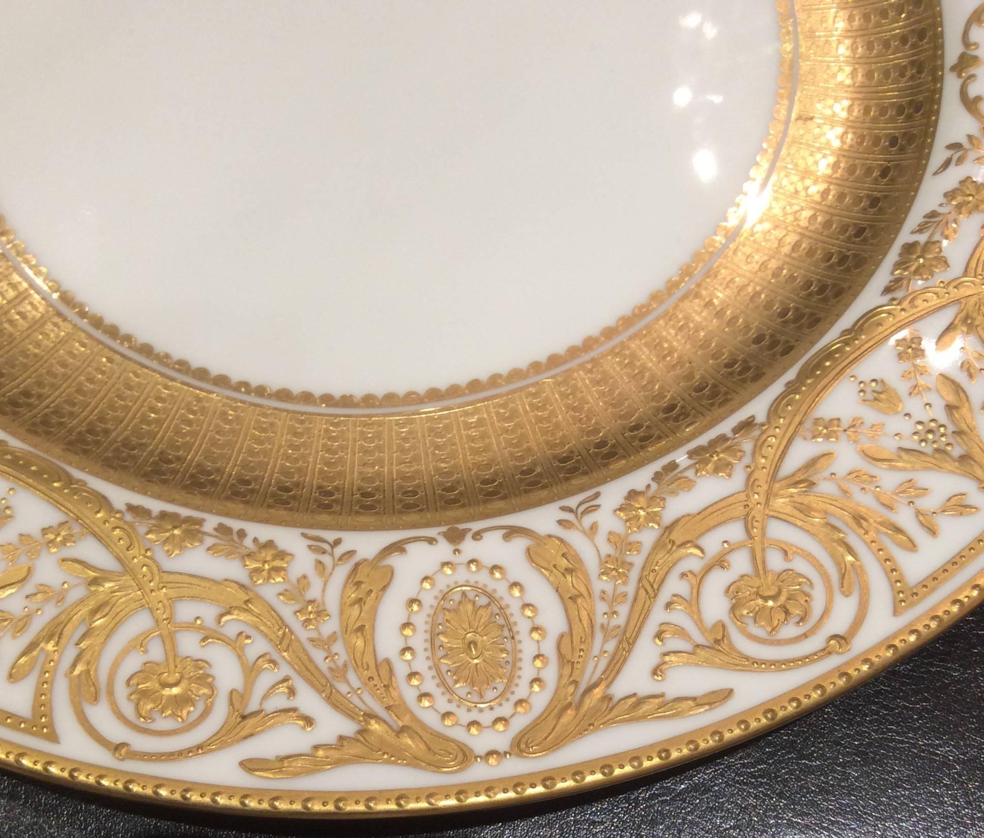 An elaborate and wonderful set of 11 dinner or presentation plates from Minton, England custom for the fine retailer: Tiffany. Raised tooled gilt floral swags, floral medallions and a stunning 24-karat wide acid etched band.