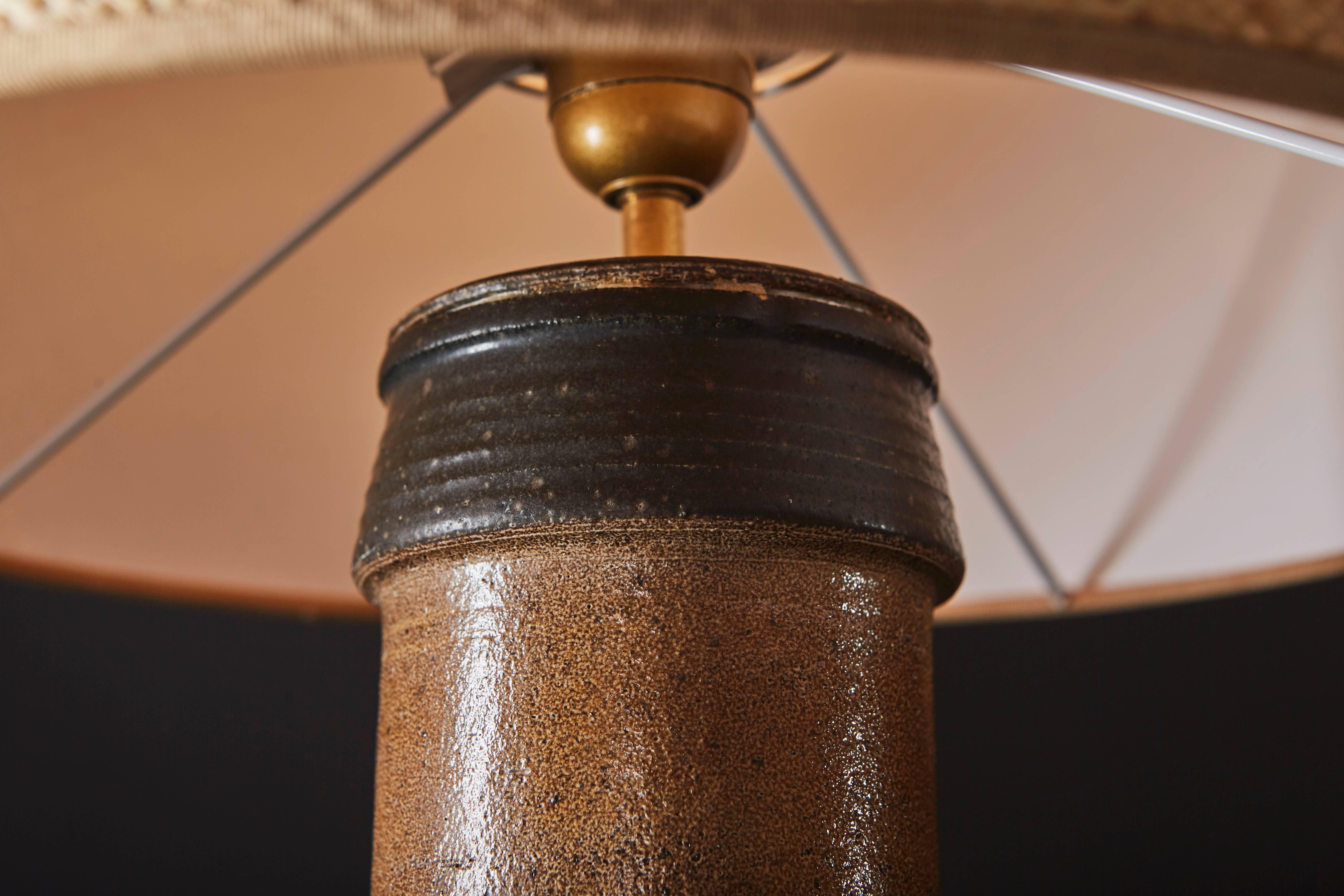 Enameled sandstone lamp. Cylindrical base in dark brown and a narrow neck in light brown.

New shade by Maison Capeline, Paris

Danish work by Kähler, circa 1950.

Lamp without shade is 21.2 in (height) and 5.9 in (diameter).