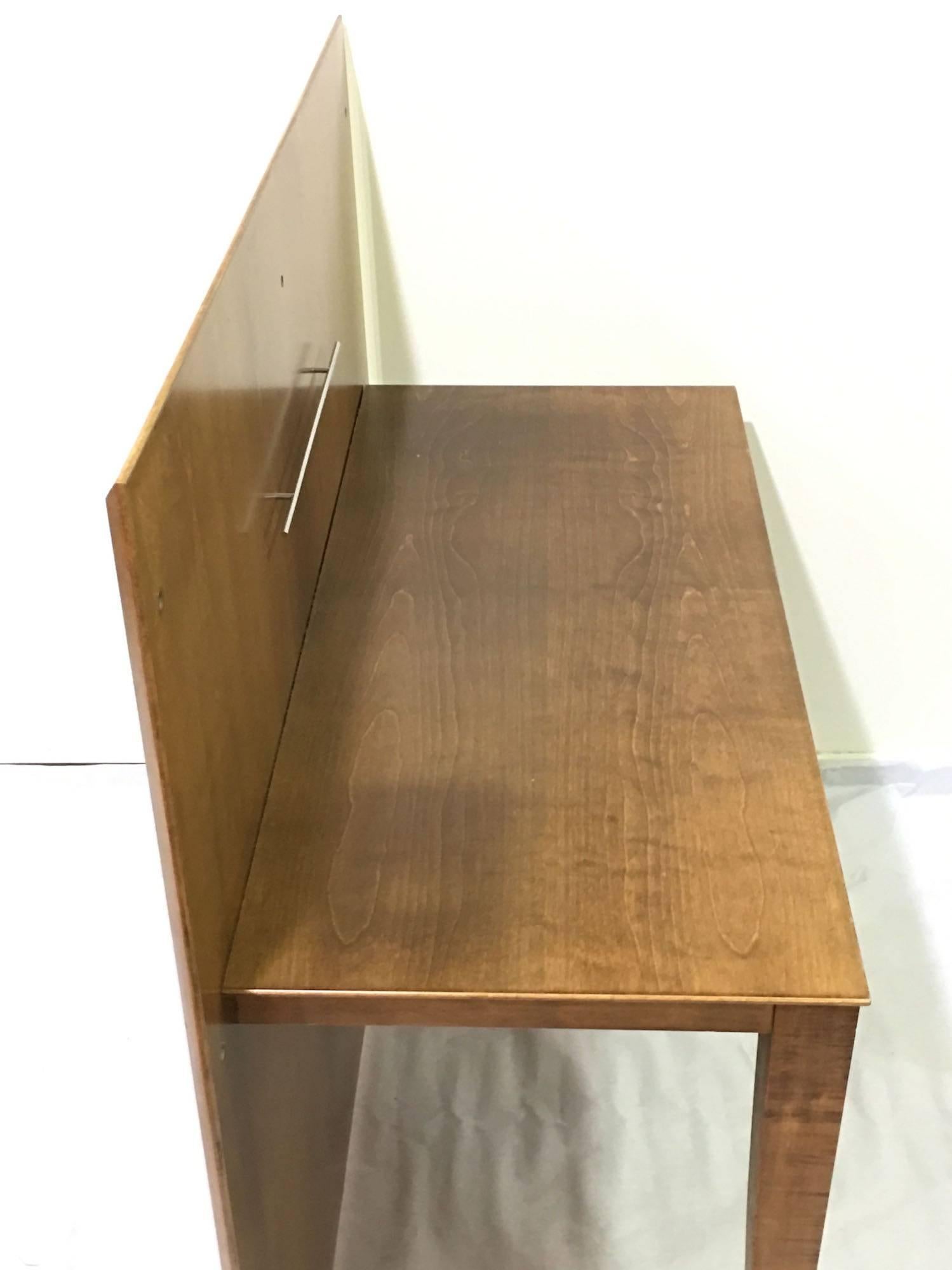 This refined sycamore varnished desk with two drawers, was designed and manufactured by Christian Liaigre for Hotel Montalembert in 1990. With this first design project of a luxury hotel, Christian Liaigre acquires its international dimension. For