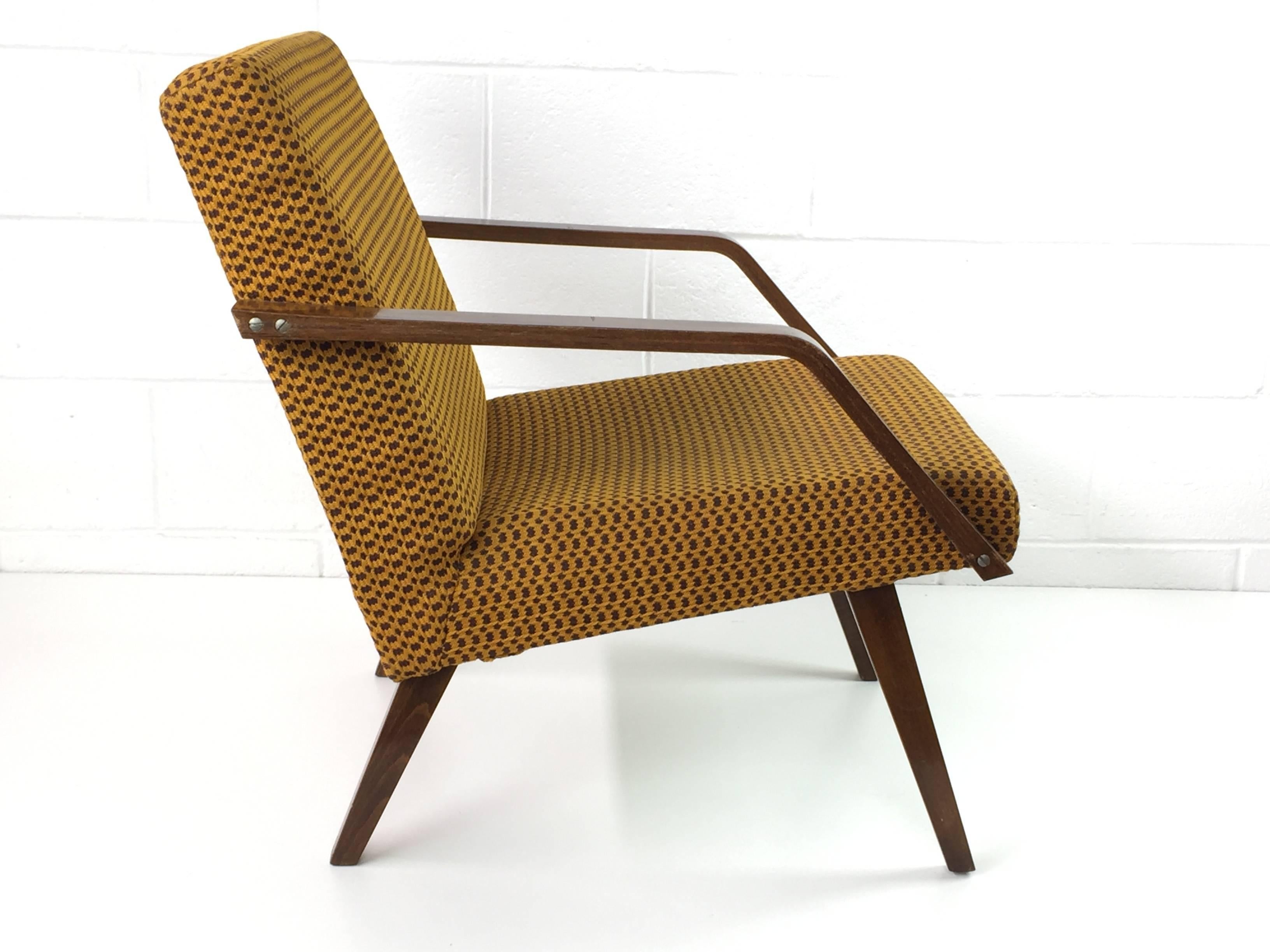 This armchair shows the Scandinavian influence on Czech design with its Minimalist form. This chair is in original condition and originates from former Czechoslovakia.