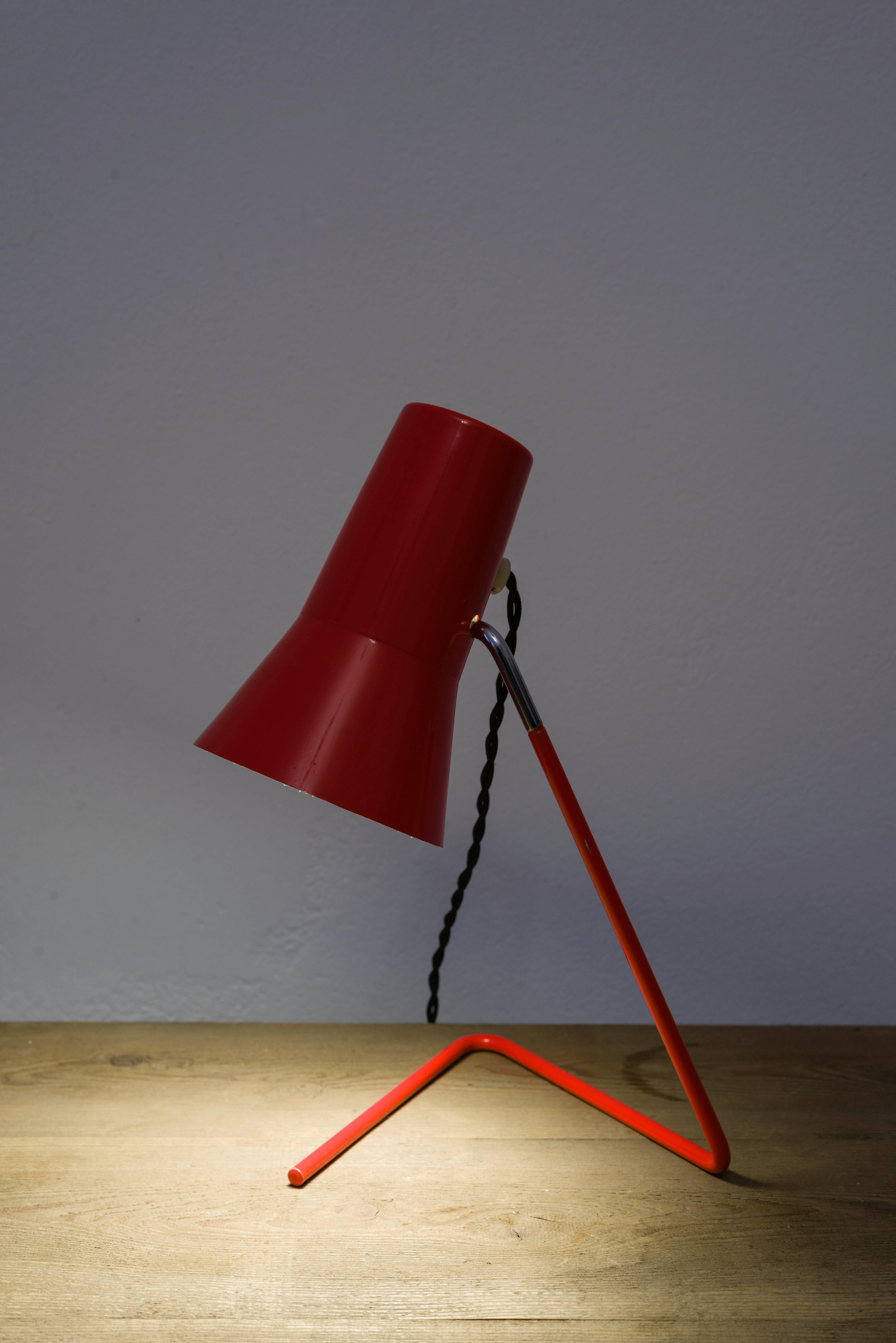 This table lamp was designed by Josef Hurka and manufactured by Napako in the Czech Republic in 1950. It features a tripod with shade made from lacquered steel plate. The shade is height adjustable. The lamp was rewired and remains in a very good
