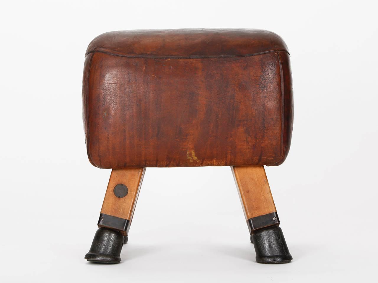 This Czech gym stool or turn bock was produced in the 1930s. It has been shortened to a height of 59 cm and has a seat upholstered in cow leather.