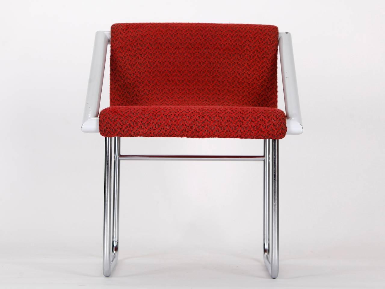 This armchair was manufactured during the 1960s in former Czechoslovakia. It features a chromed and lacquered tubular steel frame with the original fabric upholstery.