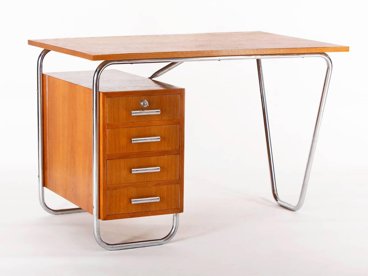This functionalist desk was made in the 1930s in the former Czech Republic.
 It features a chromed tubular steel frame and a wooden top and drawers. The wooden parts have been restored, the tubular steel is in original condition.