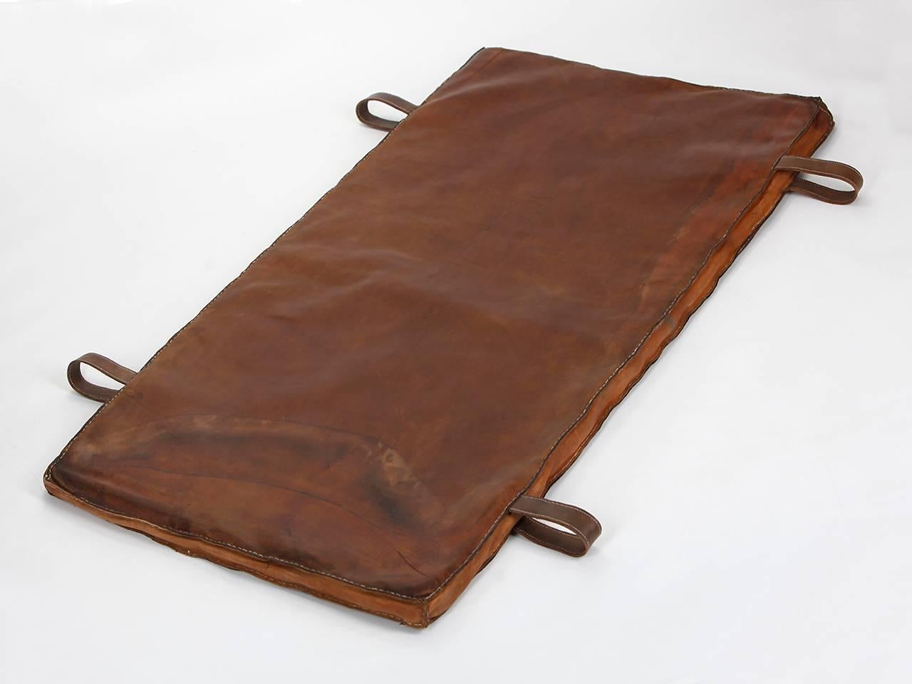 This gymnastic mat from the 1940s comes from an old Prague gym.
The thick cow leather was impregnated, and all sides sewn again. The carrying handles were added. Fully usable beautiful vintage condition.

We offer shop to door delivery worldwide.