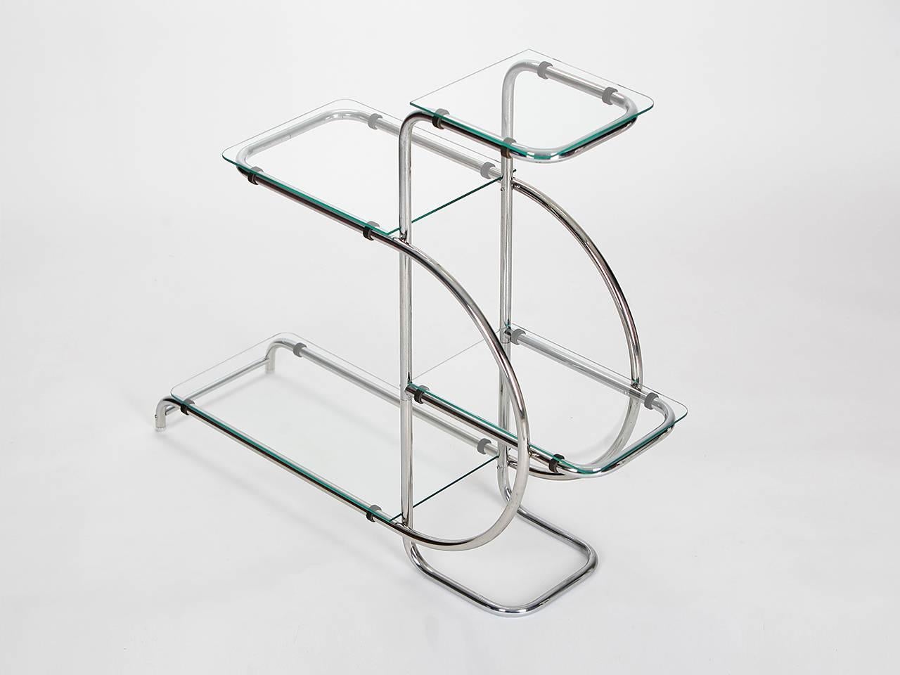 This étagère, with a frame of bent steel tube and glass shelves, was made in the 1930s in the Czech Republic. Original chromium plating in a very nice original condition. Glass plates renewed.

We offer shop to door delivery worldwide. Please ask
