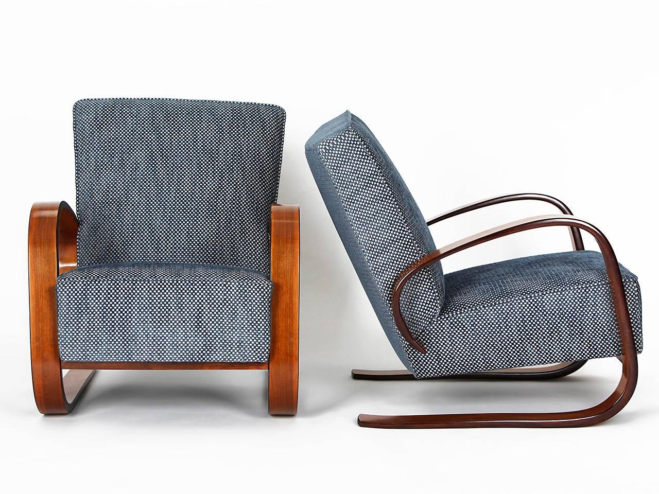Pair of cantilever chairs designed by Miroslav Navratil.
Produced by Spojene UP Zavody in the 1950s. Armchairs were completely restored, including a new spring core. Restored armrests with walnut veneer.
Upholstery covered with an English fabric