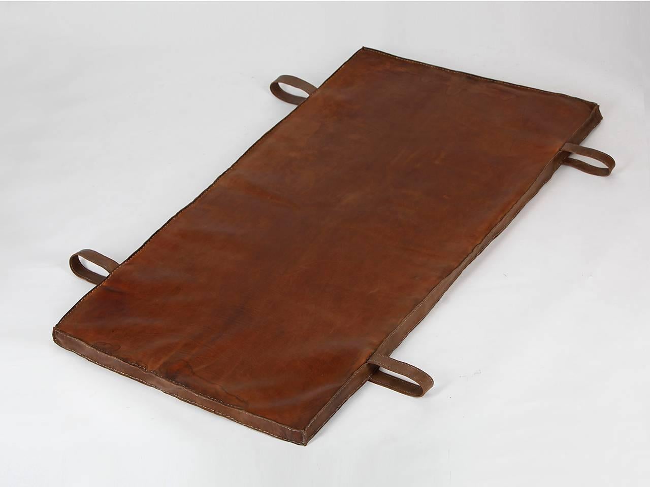 This gymnastics mat from the 1940s was salvaged from an old gymnasium in Prague. The thick cow leather was impregnated and all sides sewn again. The carrying handles were added. Fully customizable beautiful vintage condition.

We offer shop to