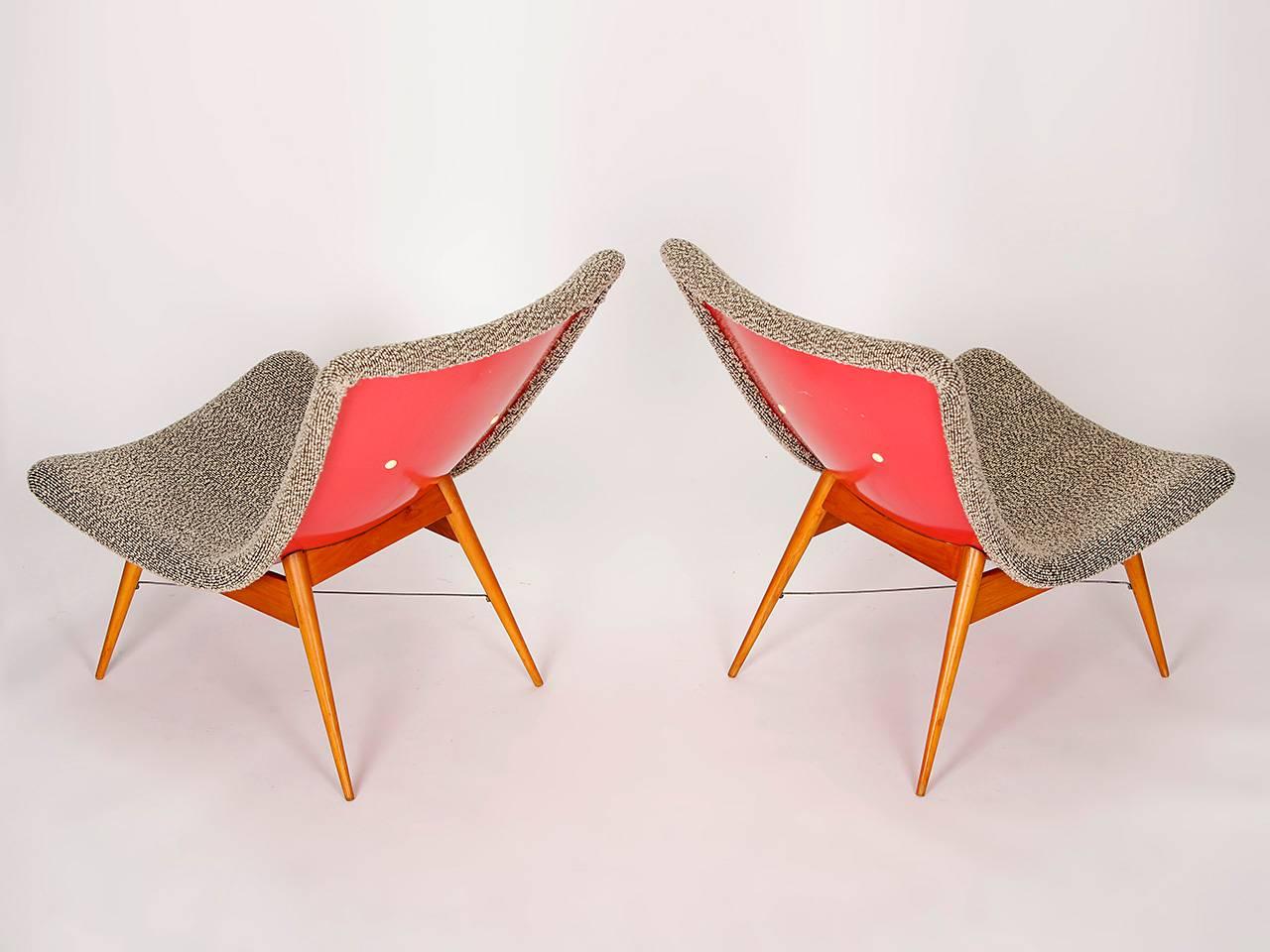 These two lounge chairs were designed in the 1960s by Miroslav Navratil for Cesky Nabytek in former Czechoslovakia. The shell seats are made of plastic laminate, the original fabric upholstery is made of sheep wool. The wooden feet have been