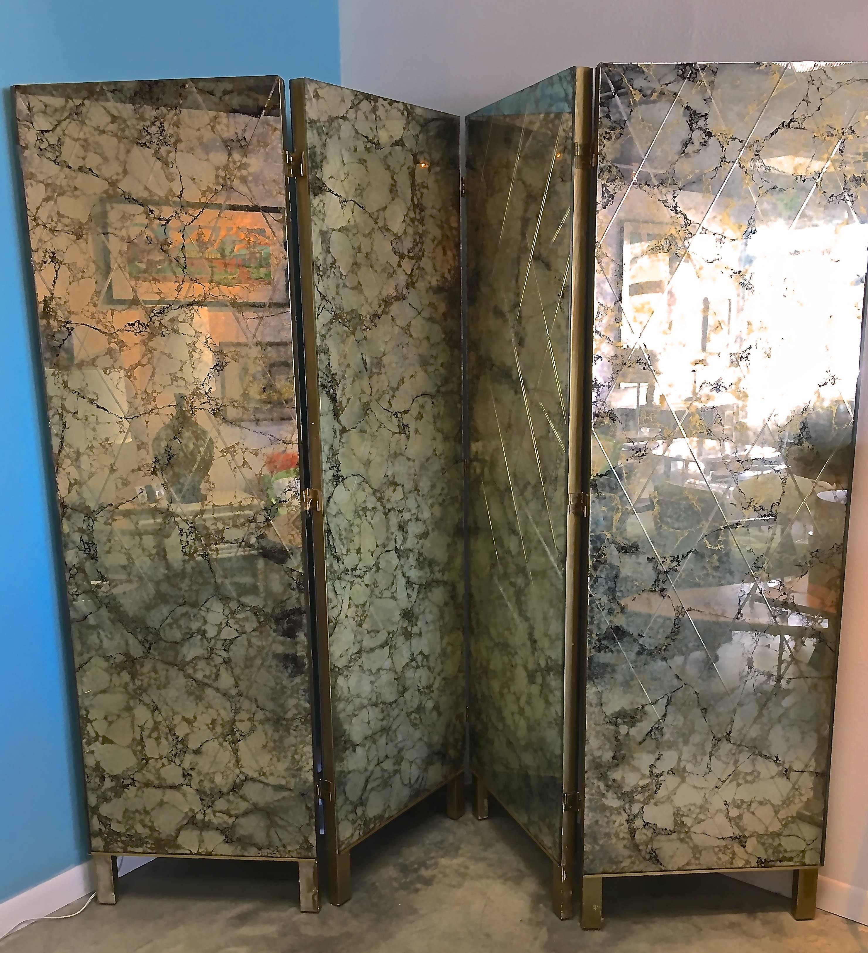 Four-panel double-sided mirrored screen of exquisite depth, with gold and black veining on a silver and smoke antiqued ground. Each side features a harlequin pattern etched into the glass panels. Mirror is mounted on solid wood panels with
