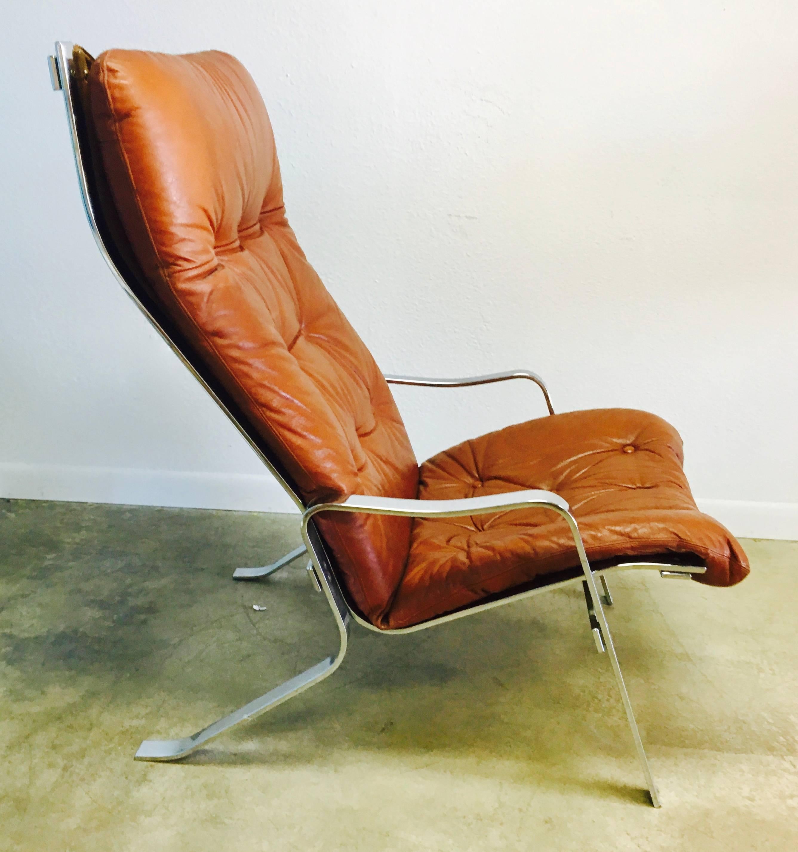Sumptuous tufted leather corset-tied with leather to a fabric sling creates an ergonomic lounge chair that exemplifies stellar Swedish design. The angular solid chrome base is substantial. Very much in the manner of Arne Norell this 1970s piece