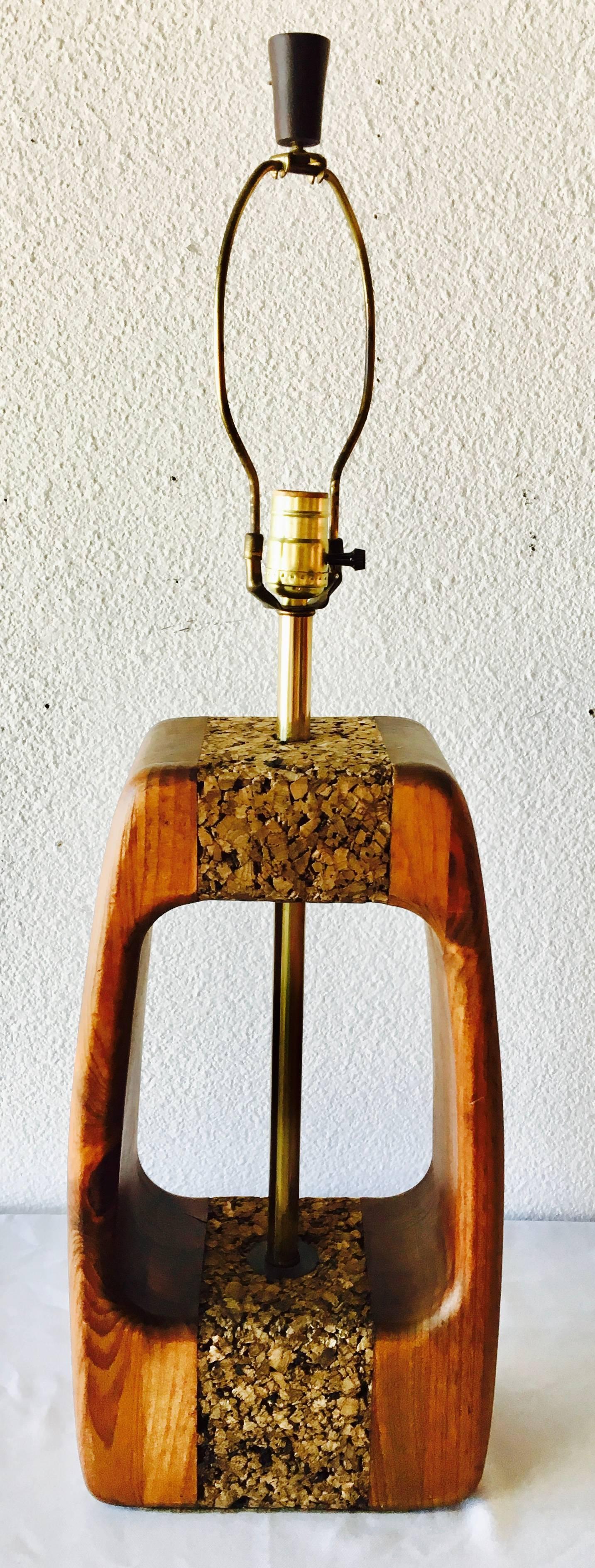 Carved walnut with cork inlays and open space revealing a center brass rod. This Mid-Century Modern beauty exemplifies the organic trends of the later 1960s into the 1970s.