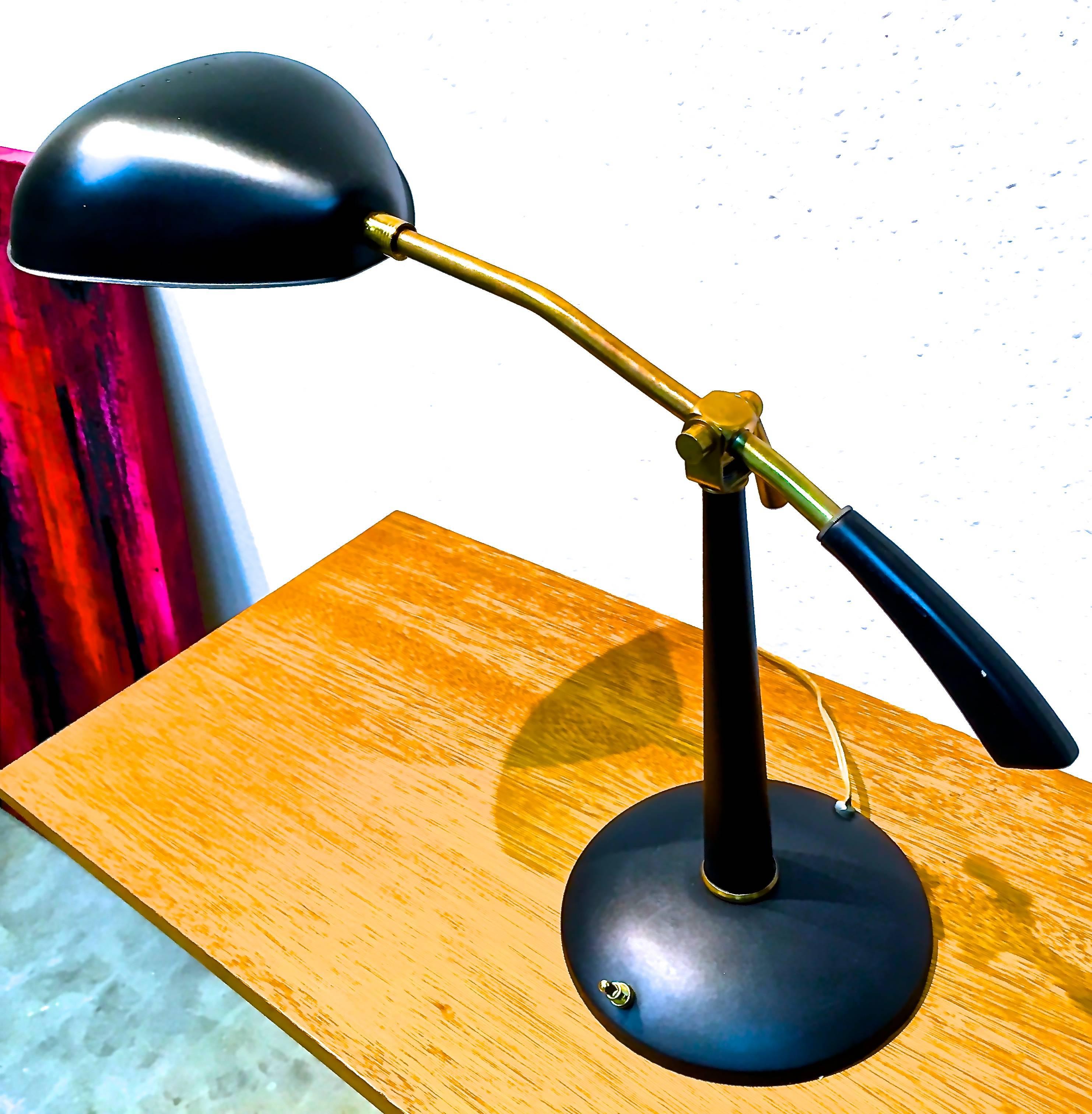 Attributed to Greta Grossman this handsome lamp has a brass arm and detailing with a satin black 