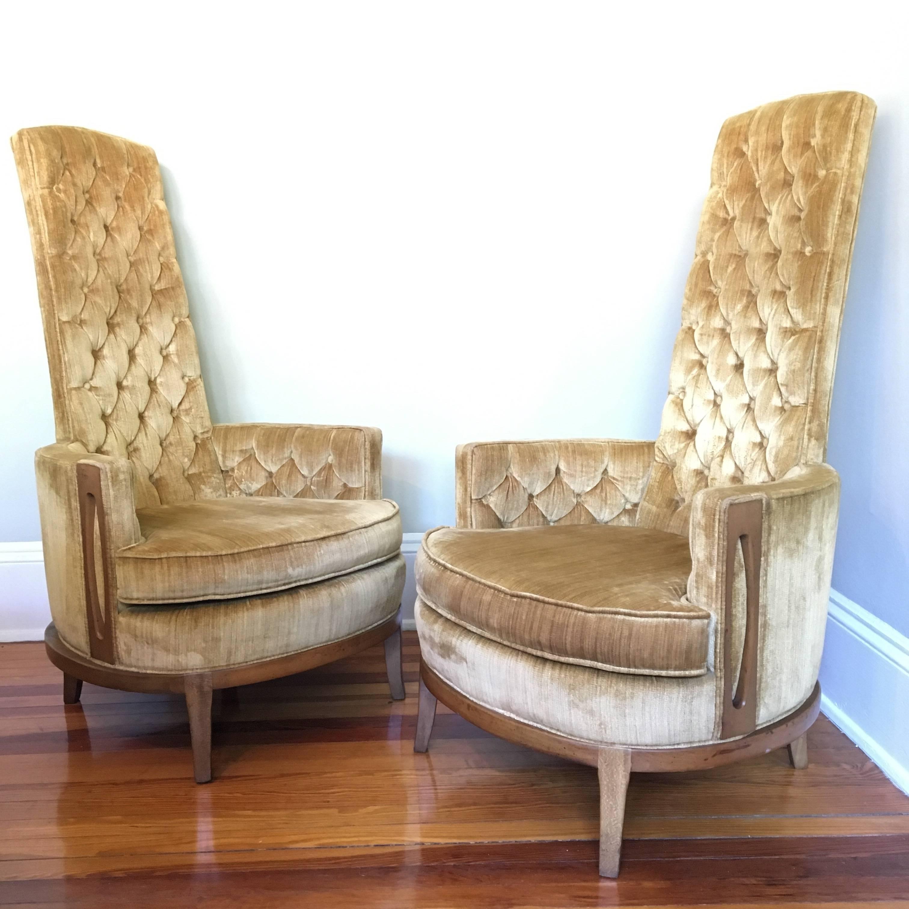Striking pair of Mid-Century Hollywood Regency high back chairs in original burnished gold tufted velvet upholstery in excellent condition. Dramatic proportions are accented with Mid-Mod wood side panels in the manner of Adrian Pearsall. Strong,