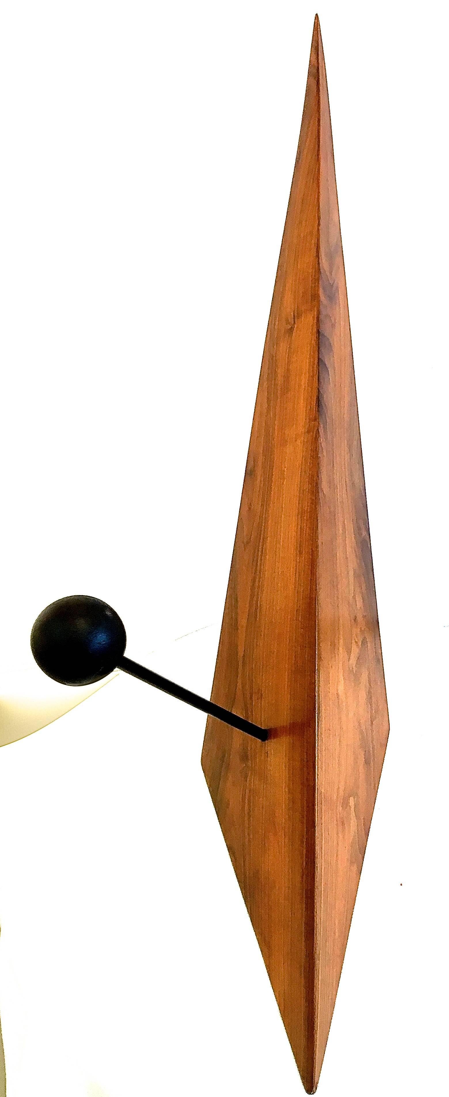 Striking and masculine this powerful sculpture is created from solid walnut pierced with an iron rod and orb. The result is a precisely balanced work of art, a one-of-a-kind piece aptly titled 