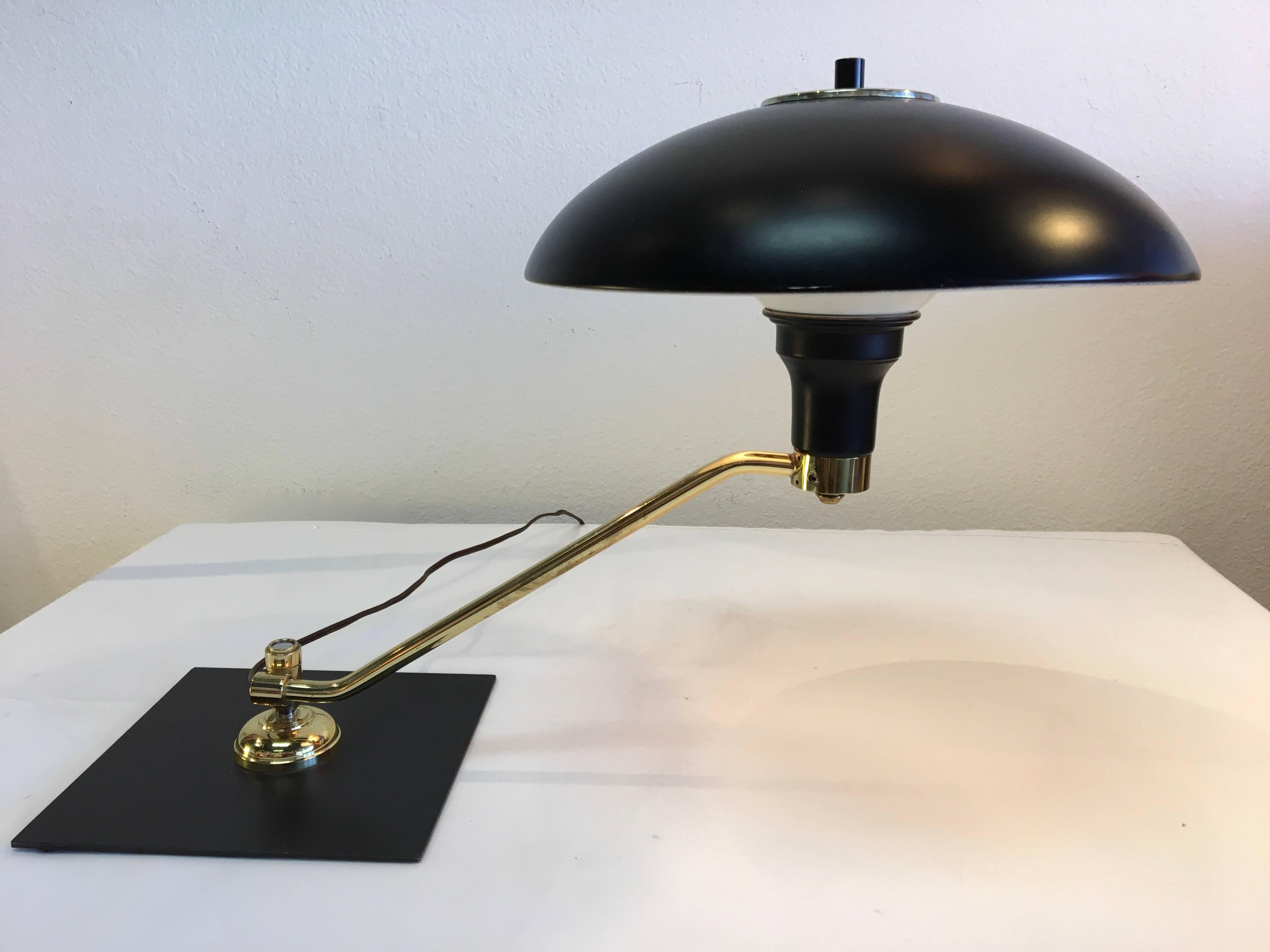 Handsome combination of satin black and polished brass combine with smooth functionality in this striking 1950s task lamp by Gerald Thurston.