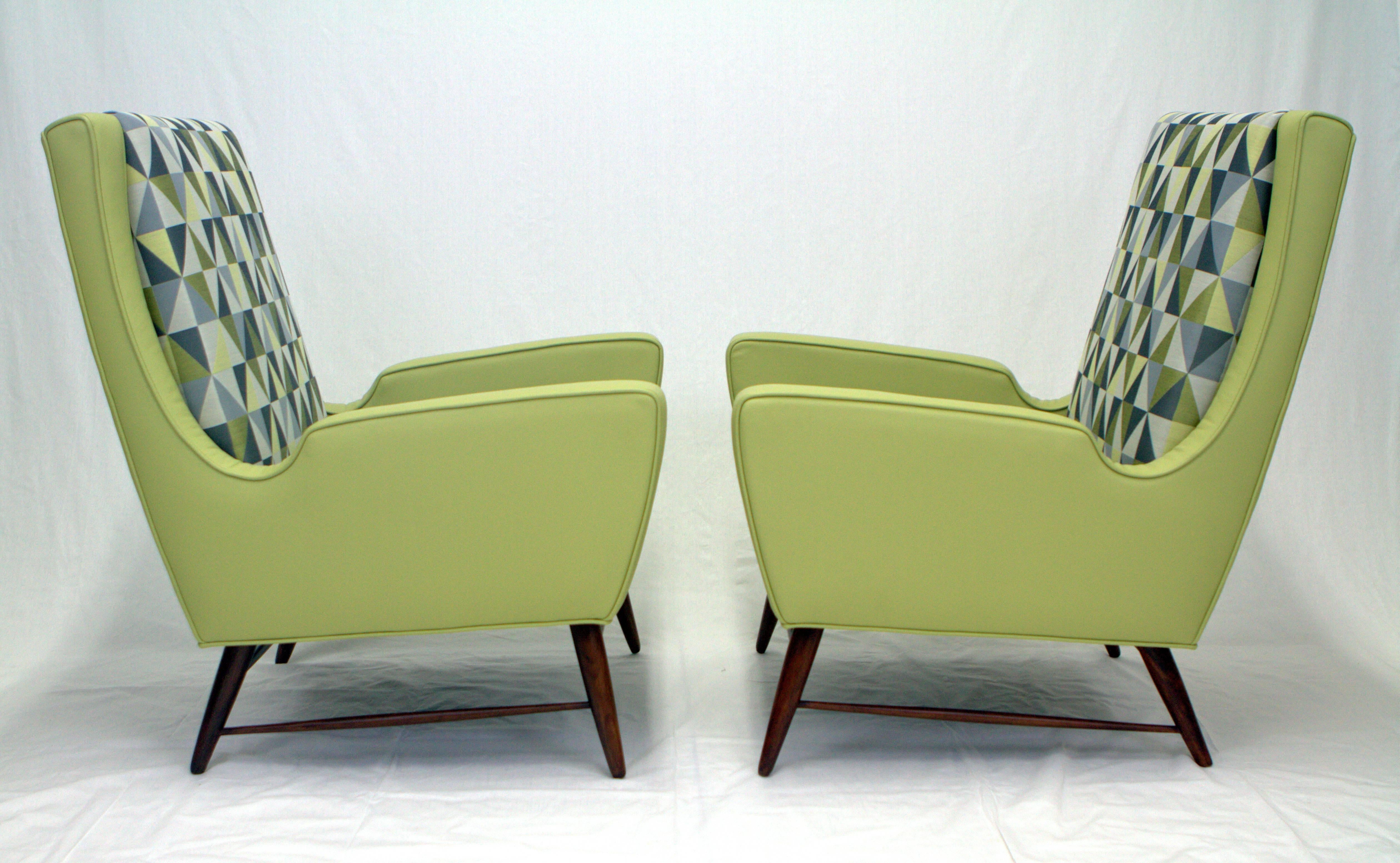 Fantastic pair of Italian lounge chairs upholstered in Ponti style diamante fabric and leather. Expressive forms give these chairs an exciting presence and shape resting on walnut doweled legs with delicate stretchers.