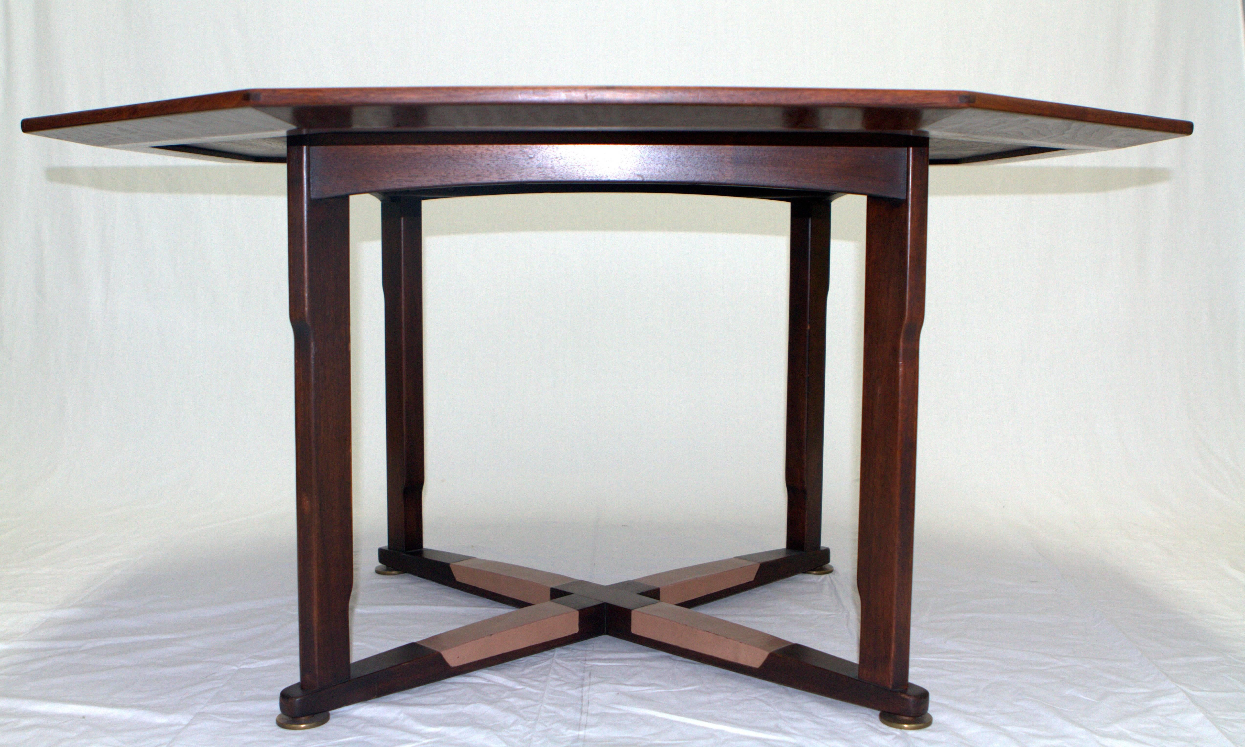 Amazing octagonal walnut game table with an inlay rosewood star by Edward Wormley for Dunbar Janus Collection. Walnut frame reminiscent of Arts and Crafts with original inset leather footrests finished with brass leveler feet. Superior construction