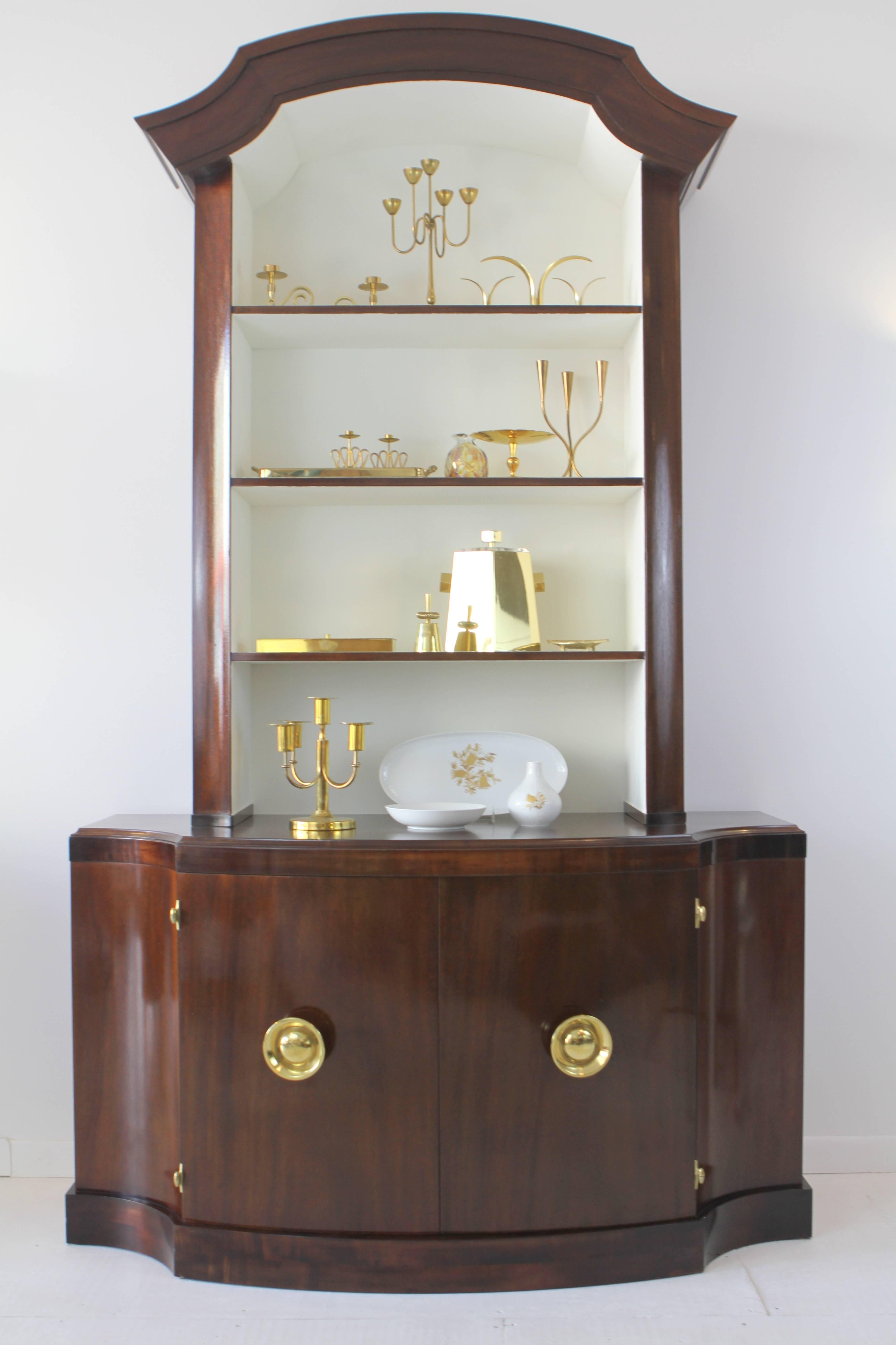 Elegant mahogany bookcase or dining hutch by Paul Frankl.  Amazing overscaled brass hardware on lower cabinet with original Tiffany Blue interior.  Upper bookcase with lacquered creamy white interior contrast with refinished mahogany case with
