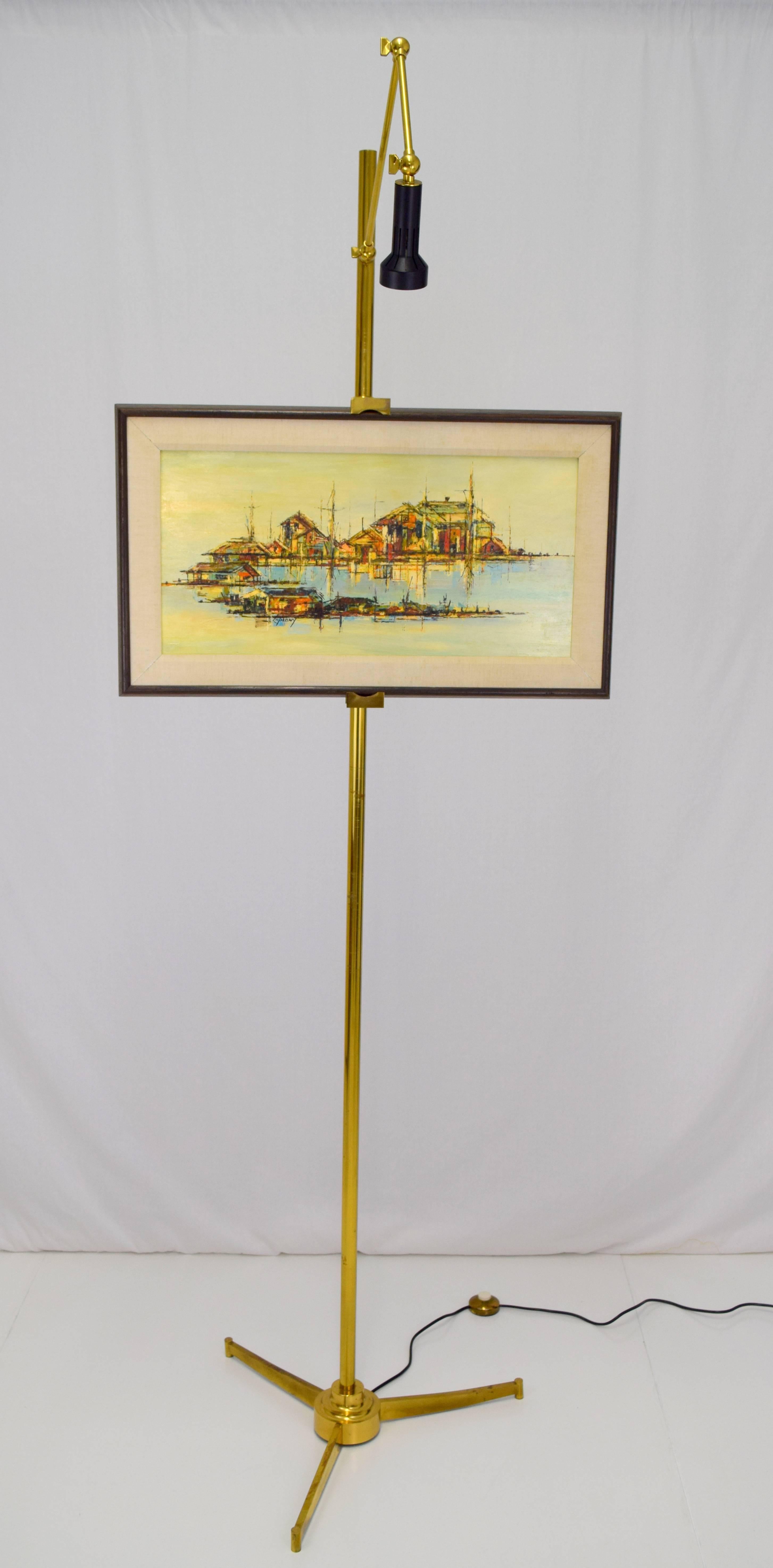 Amazing Italian easel floor lamp in brass and painted metal shade. Adjustable arms allow for various sized artworks, light source arms adjustable with excellently crafted fittings and hardware. Made in Italy stamped on underside of stepped tripod