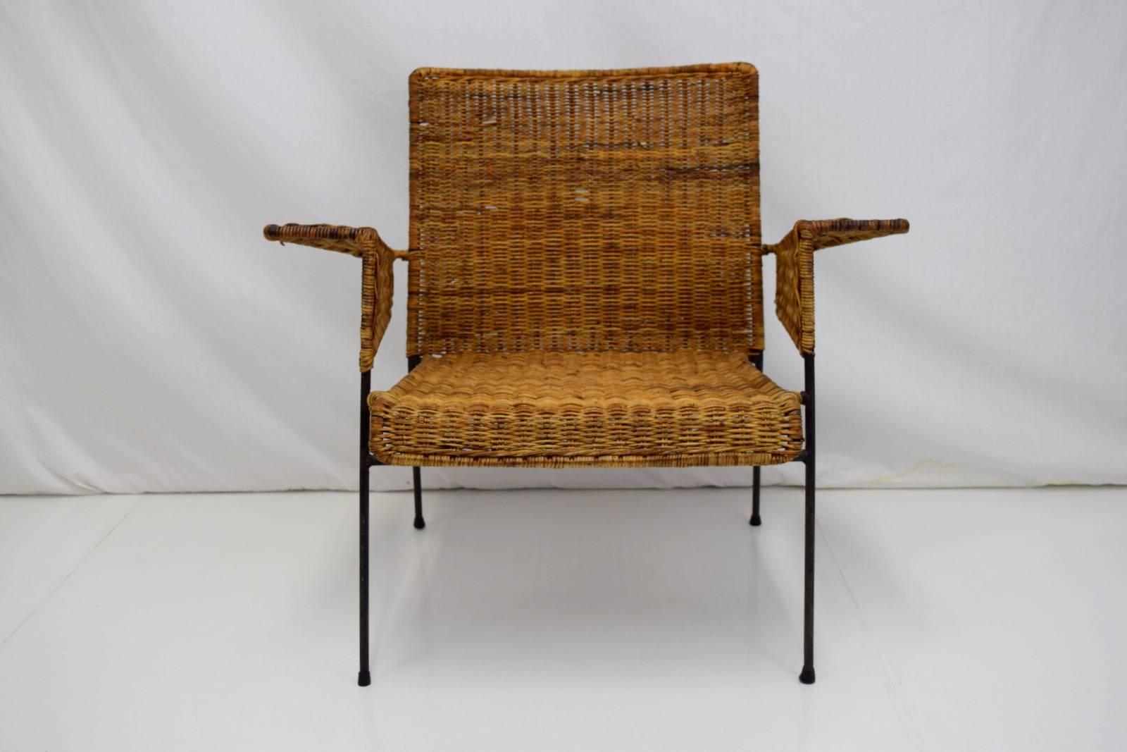 Early iron and wicker lounge chair by Van Keppel-Green. Classic California modernist lines and craftsmanship sets this chair apart. Lovely patina to wicker and iron frame with some breaks and loss to wicker. A three-piece modular set also available.