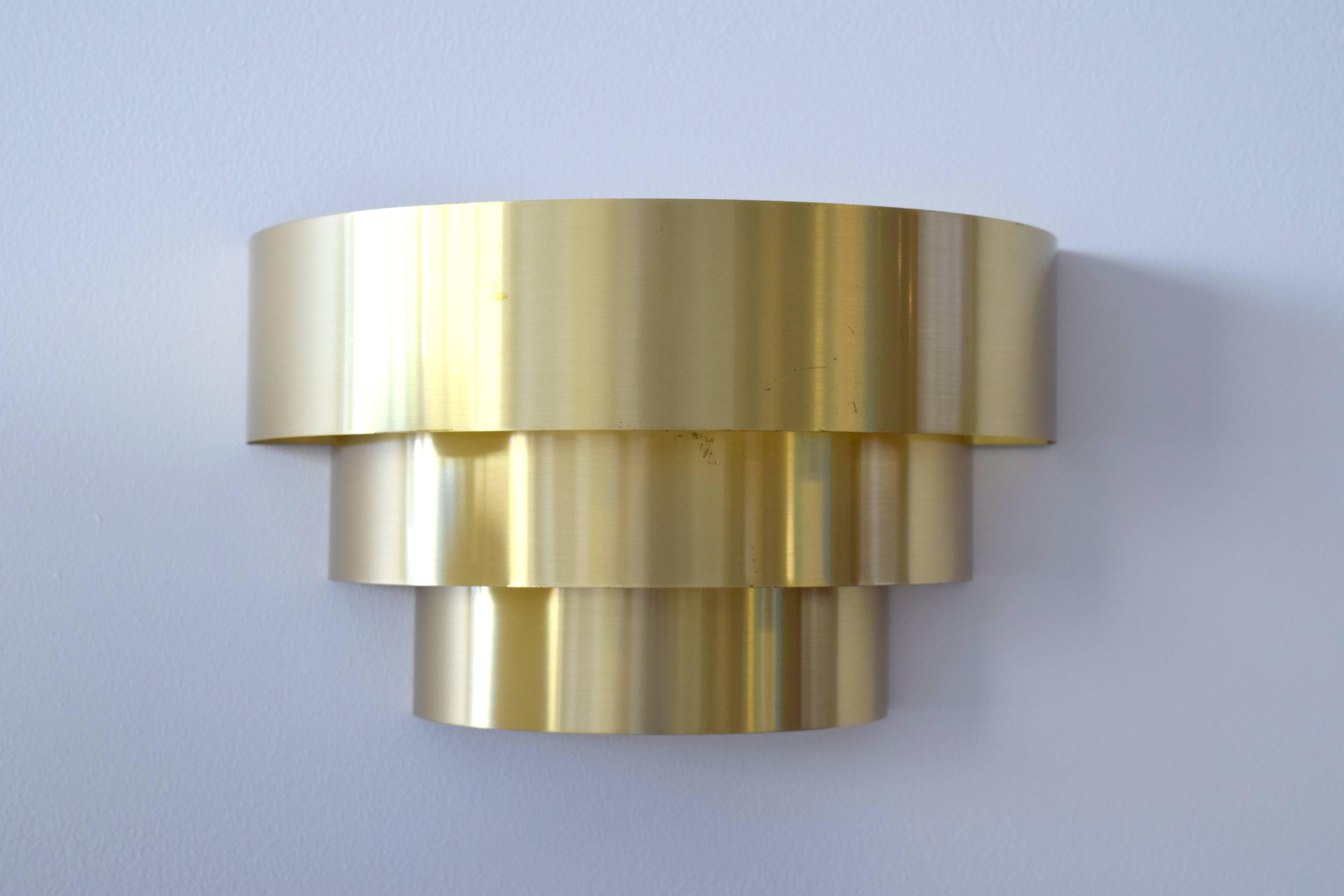 Lovely pair of brass sconces by Lightolier. Three tiers of brass ribbons graduating in size from top at 12