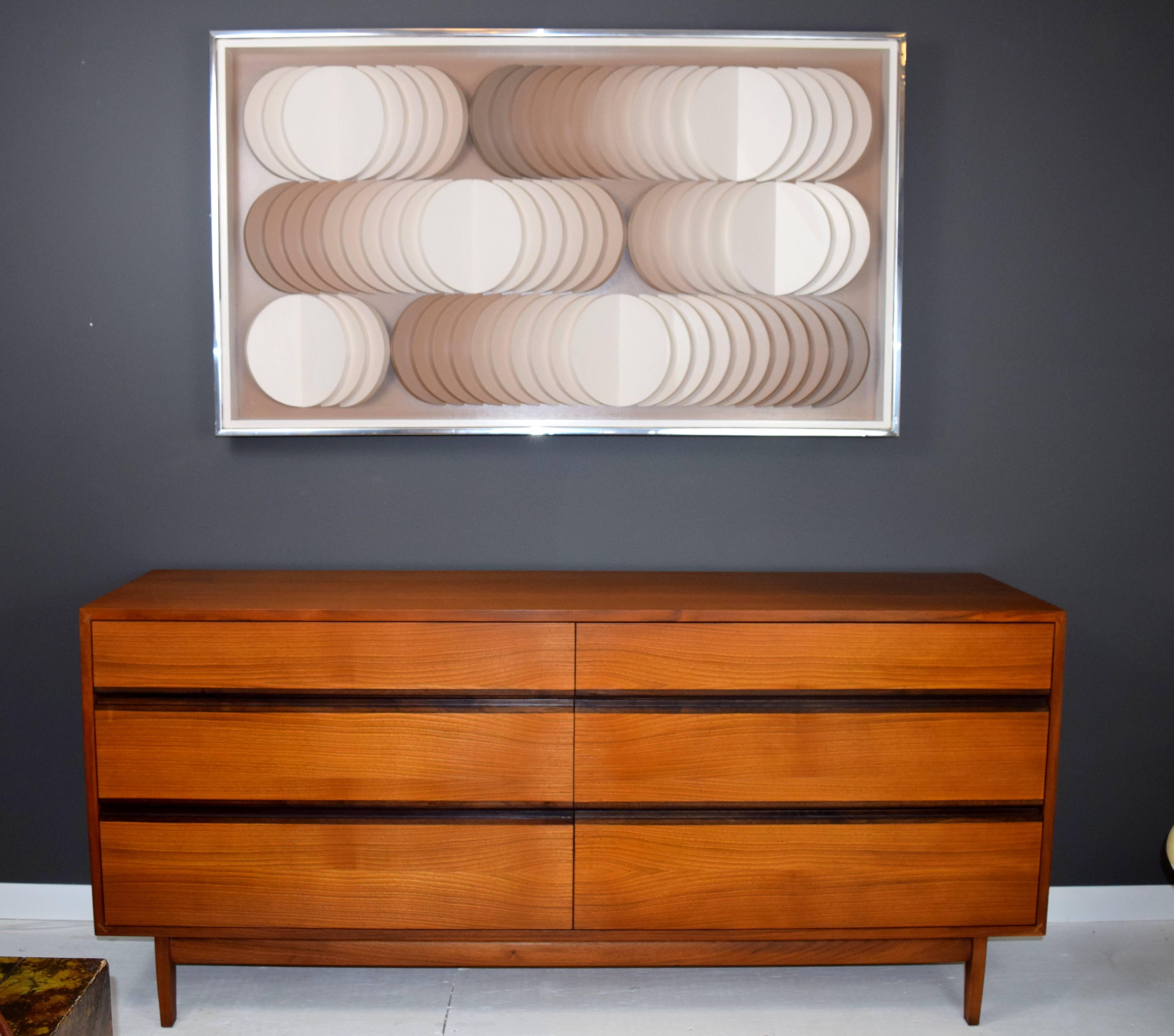 Exhilarating piece by Stephen L Winer comprised of semi circular disks radiating from varied central points. Gradation from light cream to milk chocolate gives art a sense of movement and op-art quality. Framed in deep shadow box painted in matching