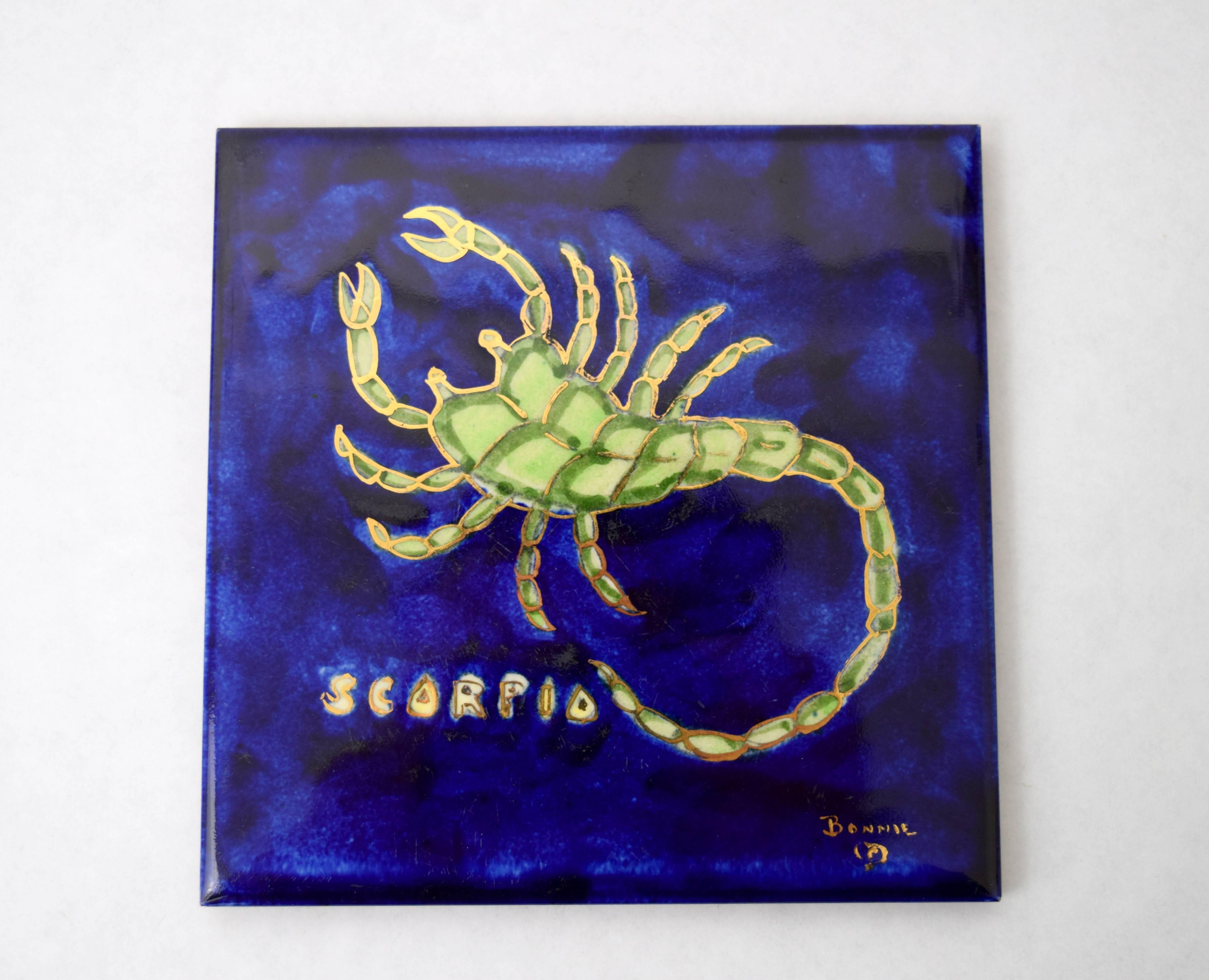 Important and rare art tile by Texas born artist Bonnie MacLeary. Beautiful deep blue and purple glaze with green scorpion figure highlighted in gold. Signed lower right, original felt back with paper label intact.
