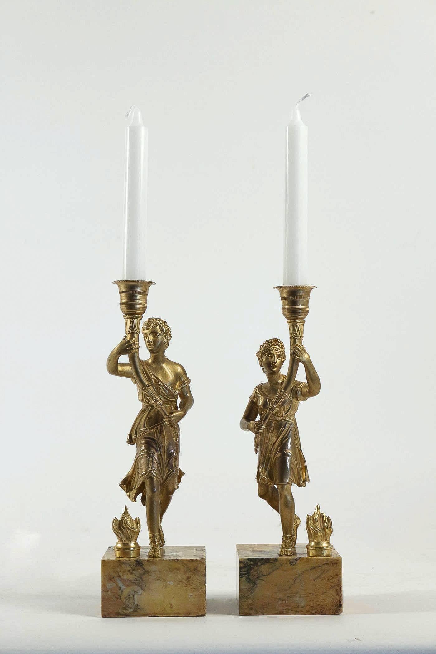 A lovely and elegant pair of candlesticks, depicting a couple antique characters in gilt bronze finely chiseled. Our candlesticks raised on Sienne marble bases.

Excellent and ornamental pair of candlesticks, circa 1850.

Dimensions: H 12.59 in.