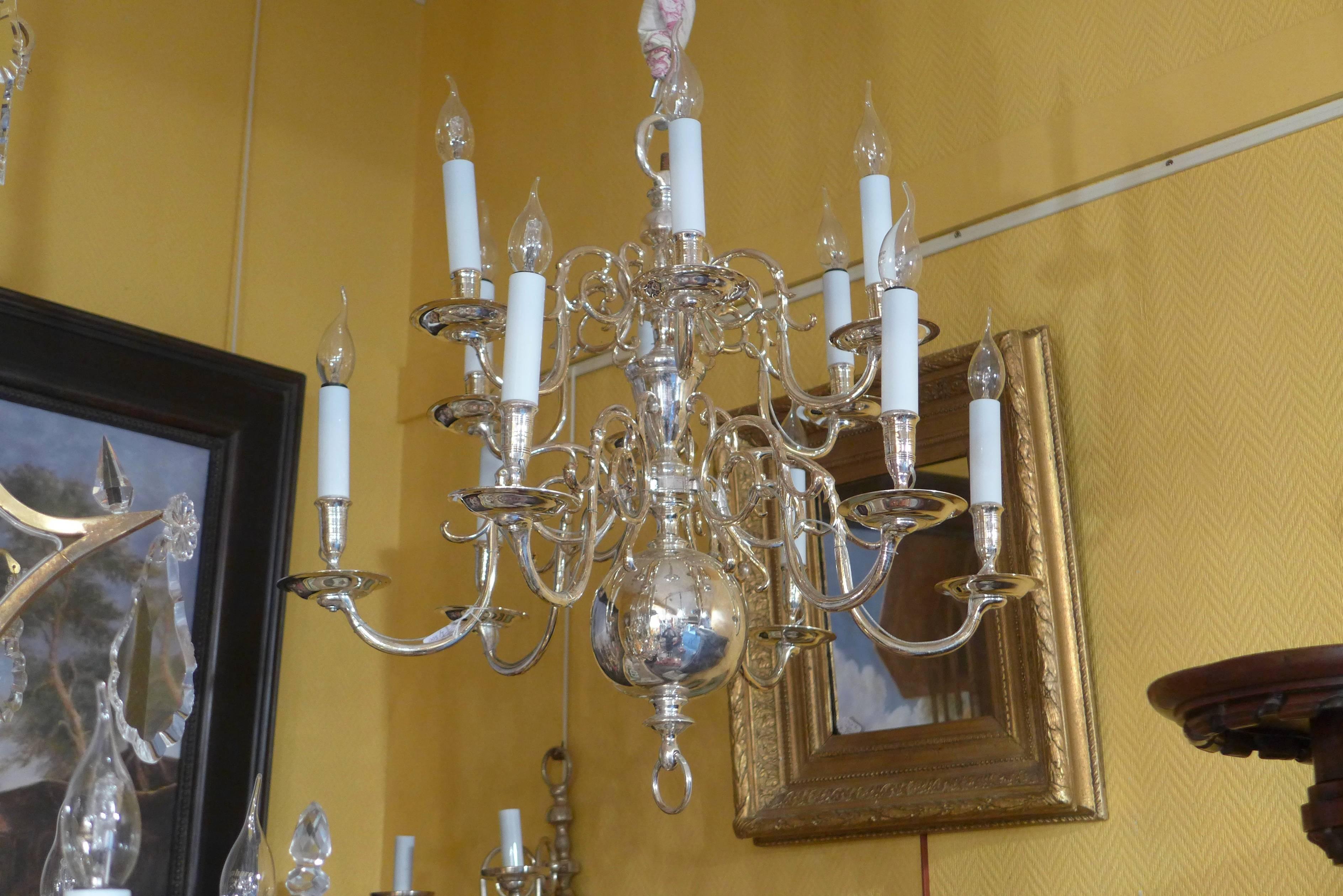 We are pleased to present you, a lovely late-18th-century Dutch baroque silver-plate chandelier, two-tier with twelve removable arm-lights. 

Our chandelier is in excellent condition. It polished and silvered professionally.
It professionally wired