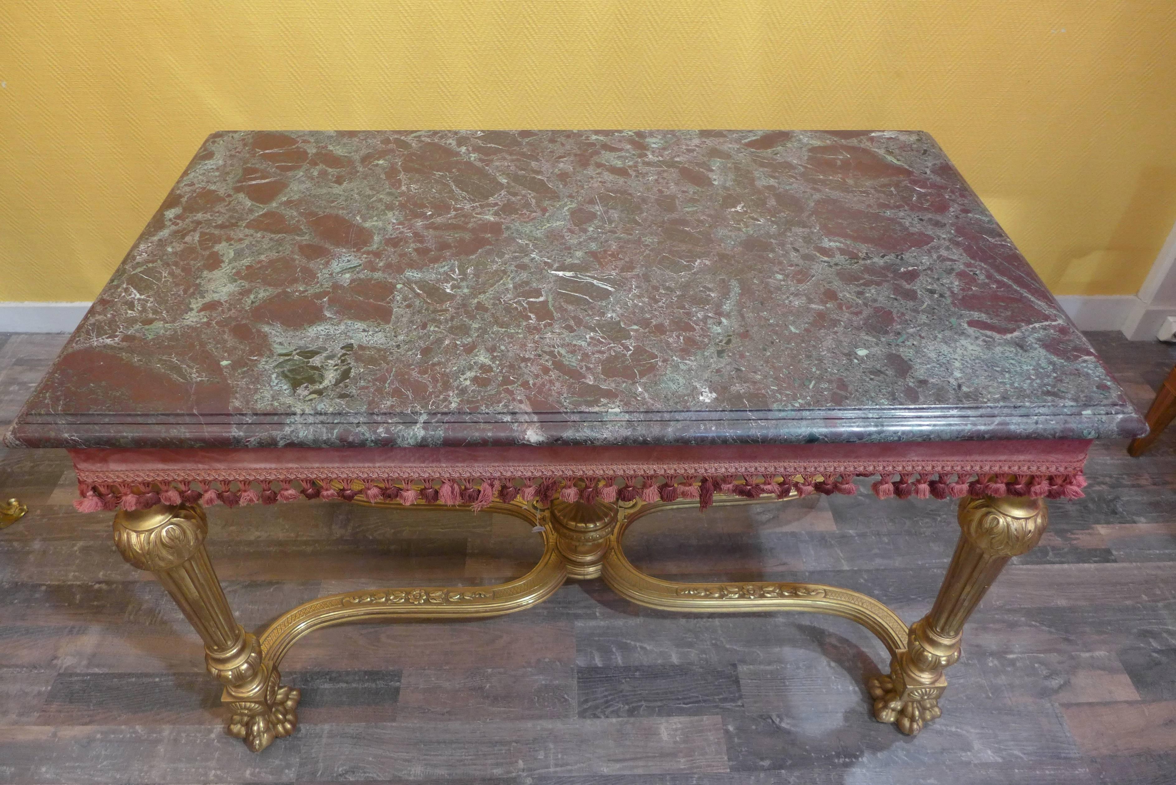 An elegant French hand-carved giltwood console table with a marble top. 
It raised on four hand-carved straight legs, terminating claw feet and stretchers meeting in a giltwood carved urn.
Georgous marble top, 