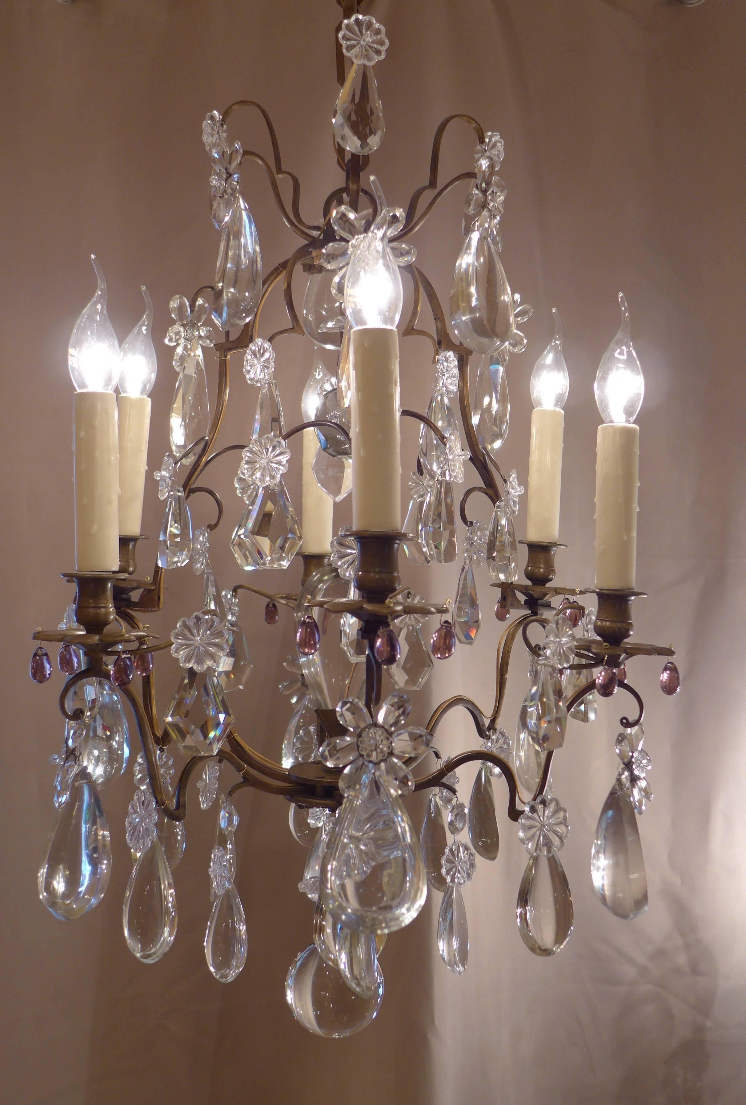 Lovely small patinated bronze and crystal form cage chandelier in the classical Louis XV style. The chandelier is composed of six arm lights. Interesting and gorgeous top quality crystal pieces, one central crystal half-pear, and crystal