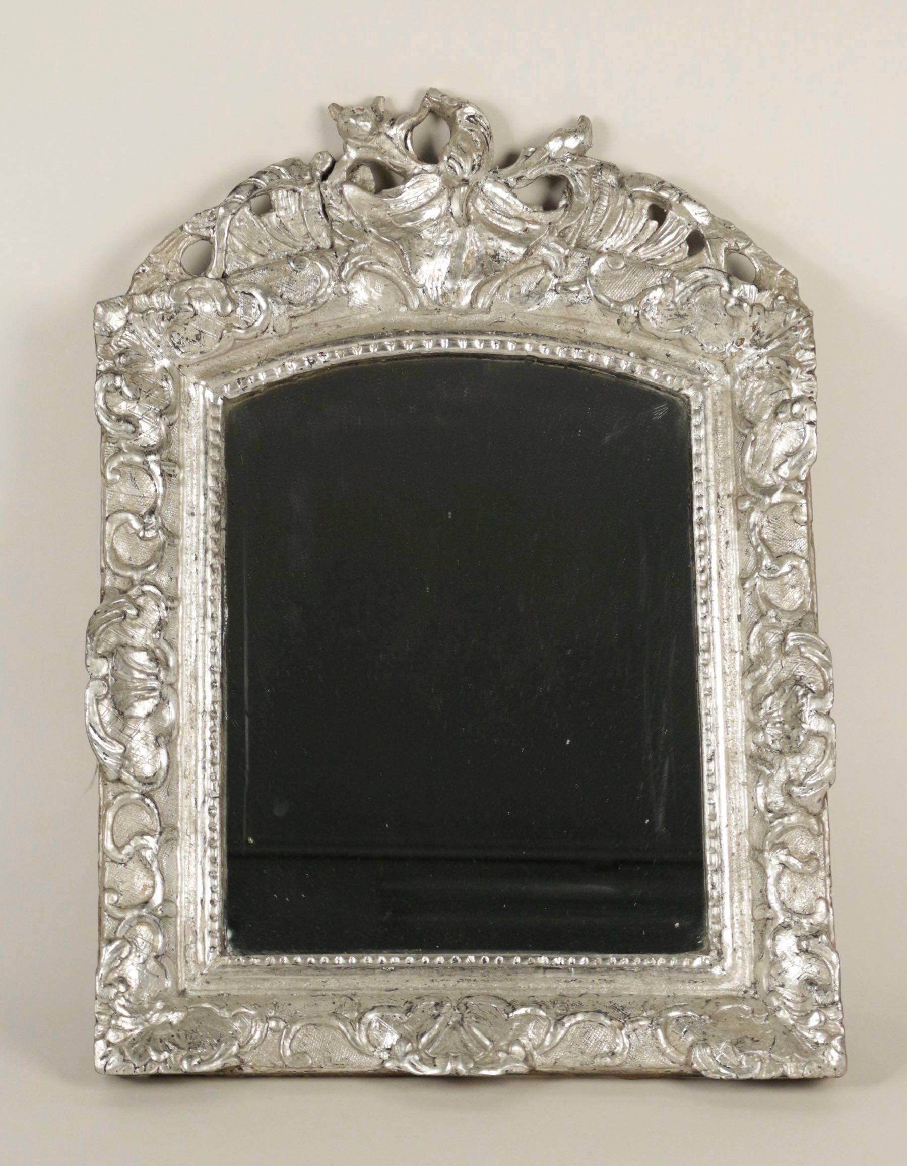 Lovely small silvered wood mirror with original mercury glass. The hand-carved frame representing Berain decor style.
French Louis XV period, mid-18th century, circa 1760.